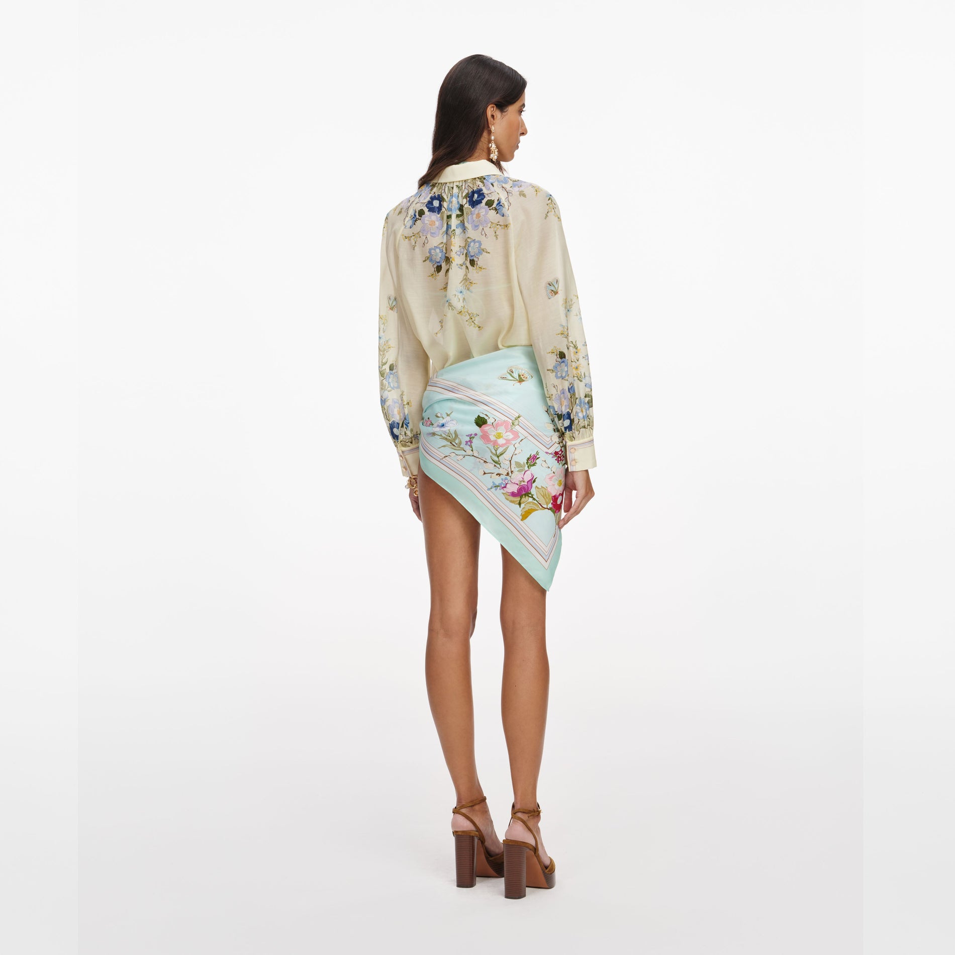 Back view of a woman wearing the Yellow Floral Organza Blouse