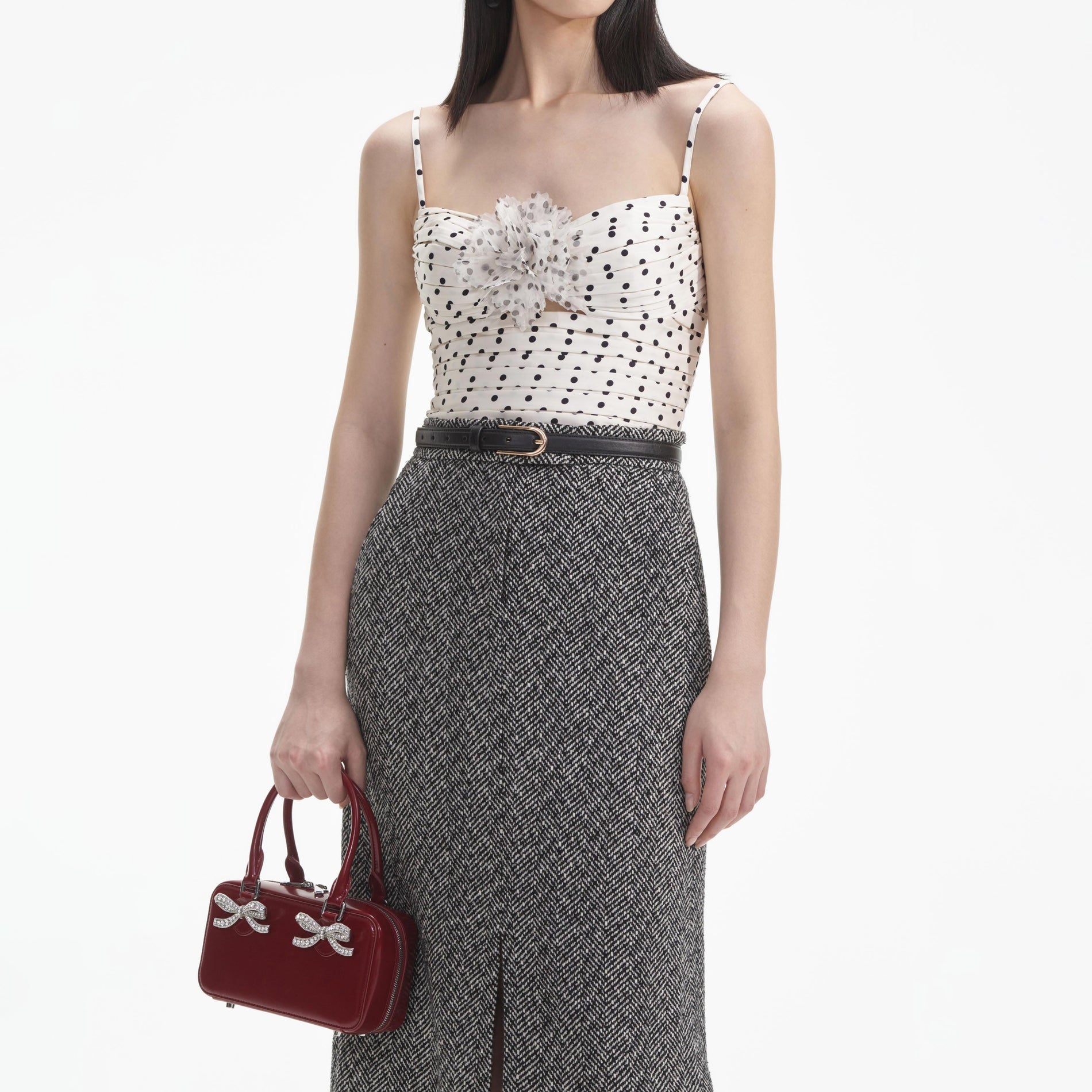 A close up of a woman wearing the Cream Polka Dot Satin Top