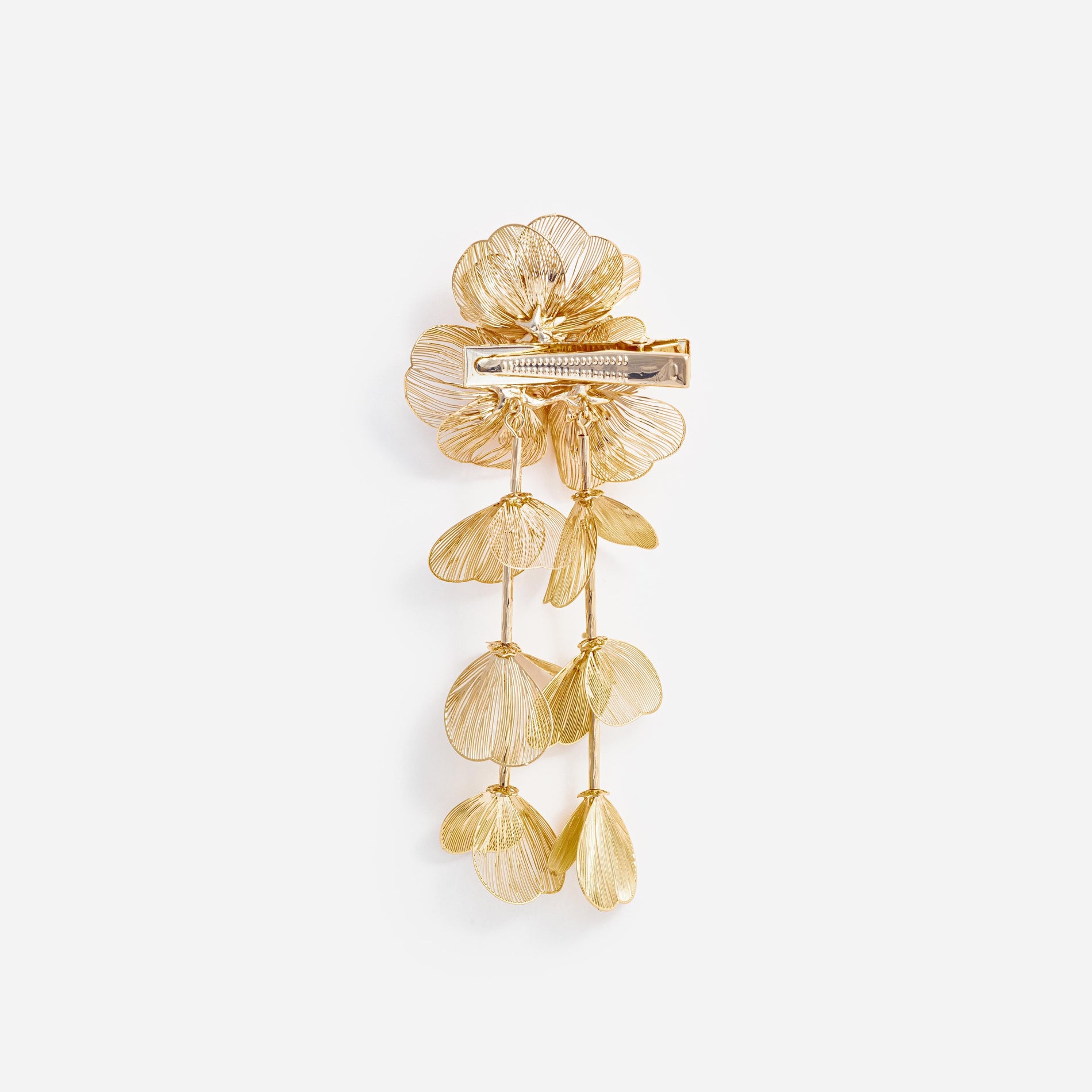 Side view of a woman wearing the Gold Floral Hairclip