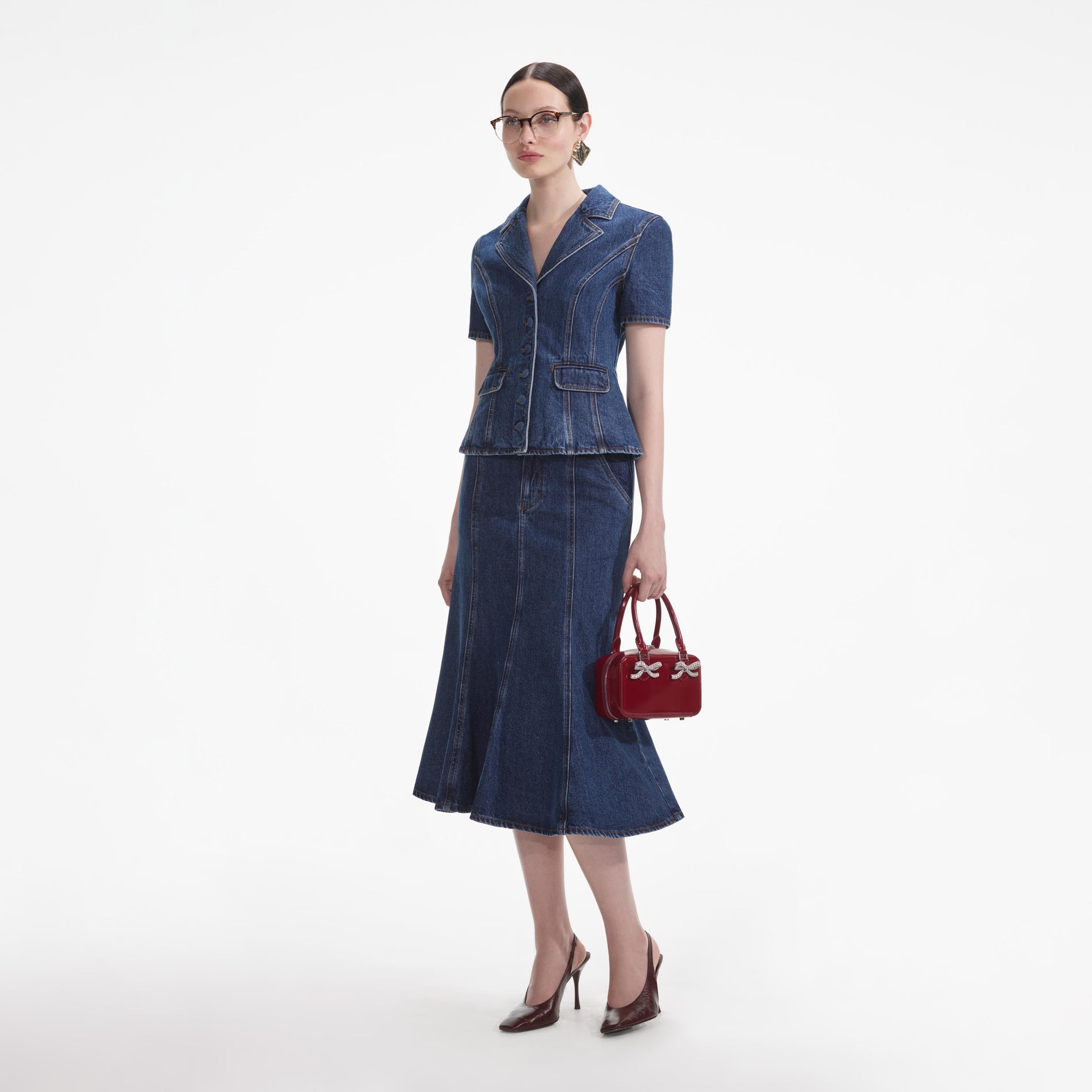 Side view of a woman wearing the Flared Denim Midi Dress