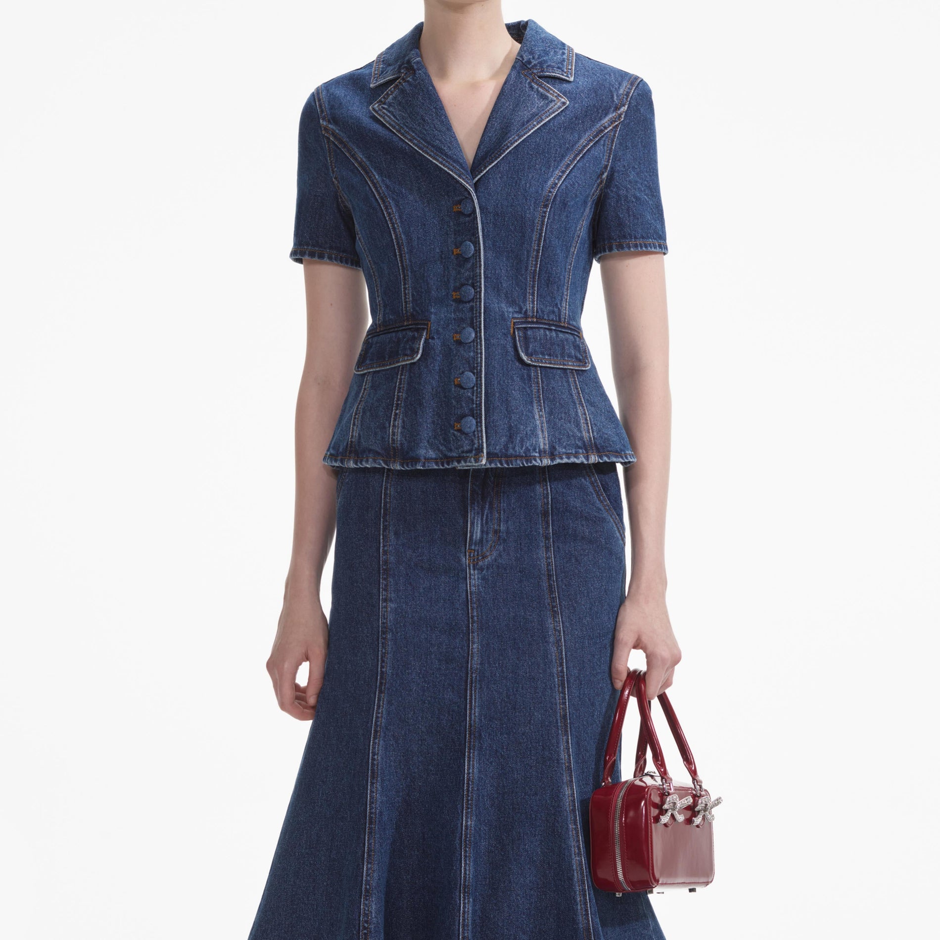 A close up of a woman wearing the Flared Denim Midi Dress