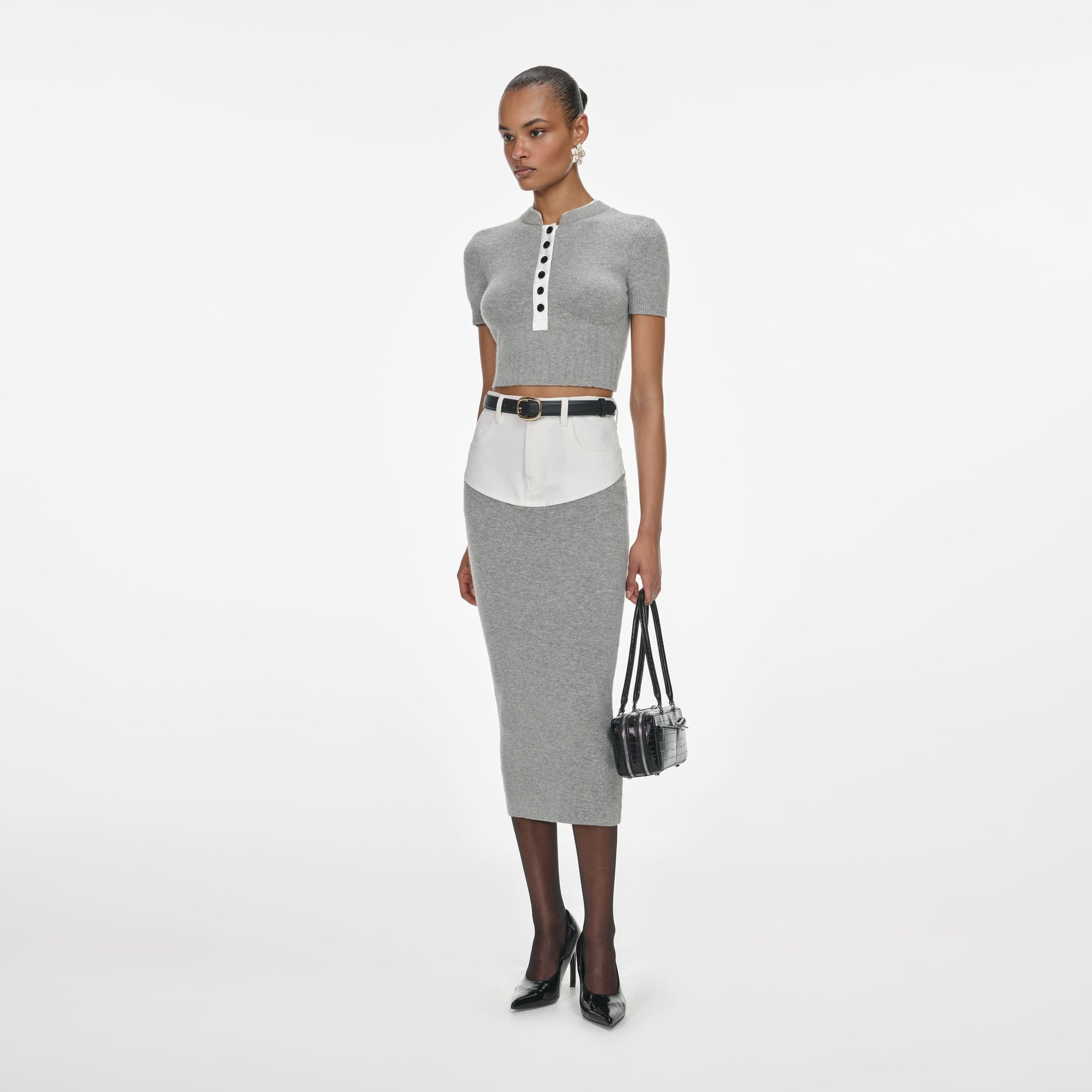 Side view of a woman wearing the Grey Short Sleeve Knit Top