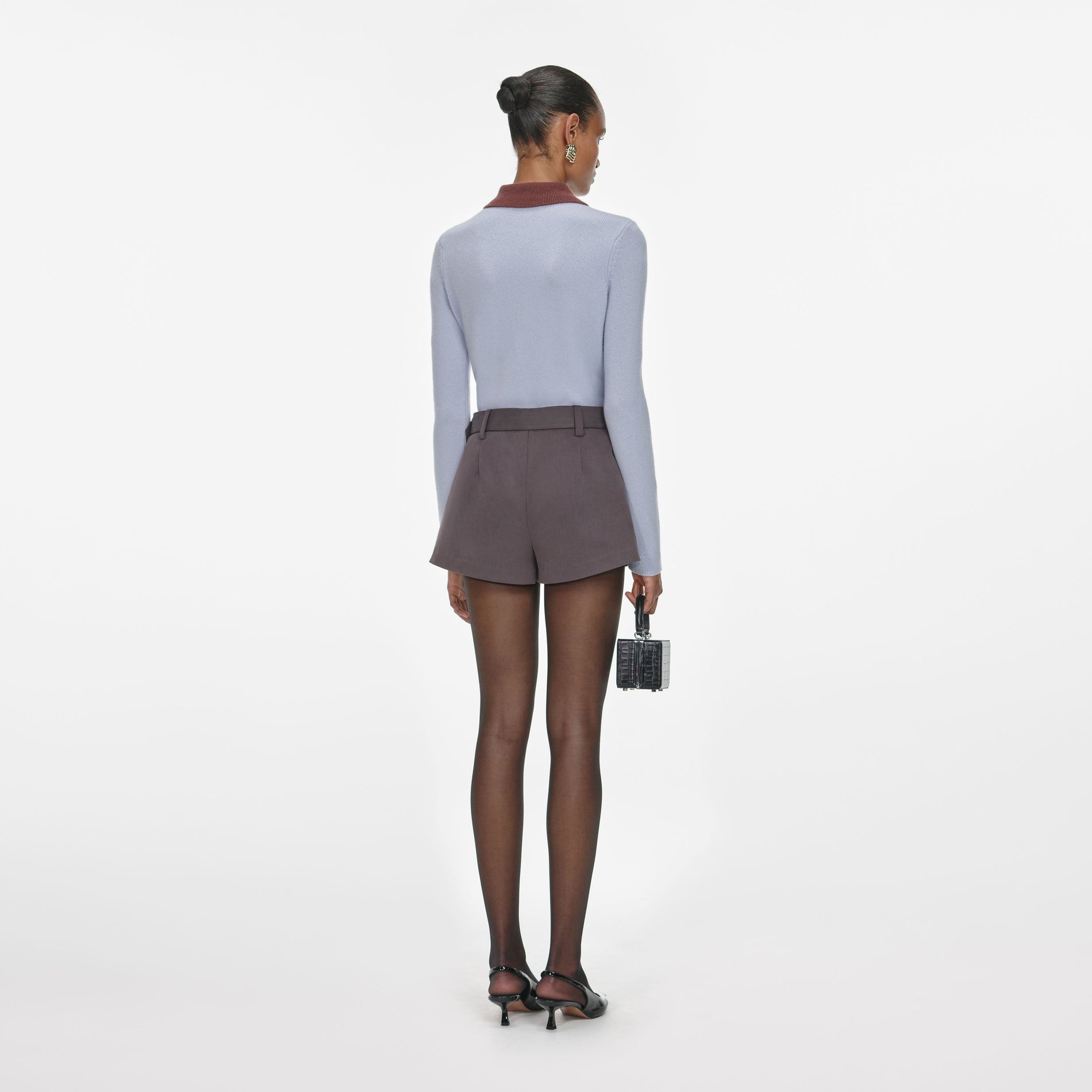 Back view of a woman wearing the Blue Contrast Collar Knit Top