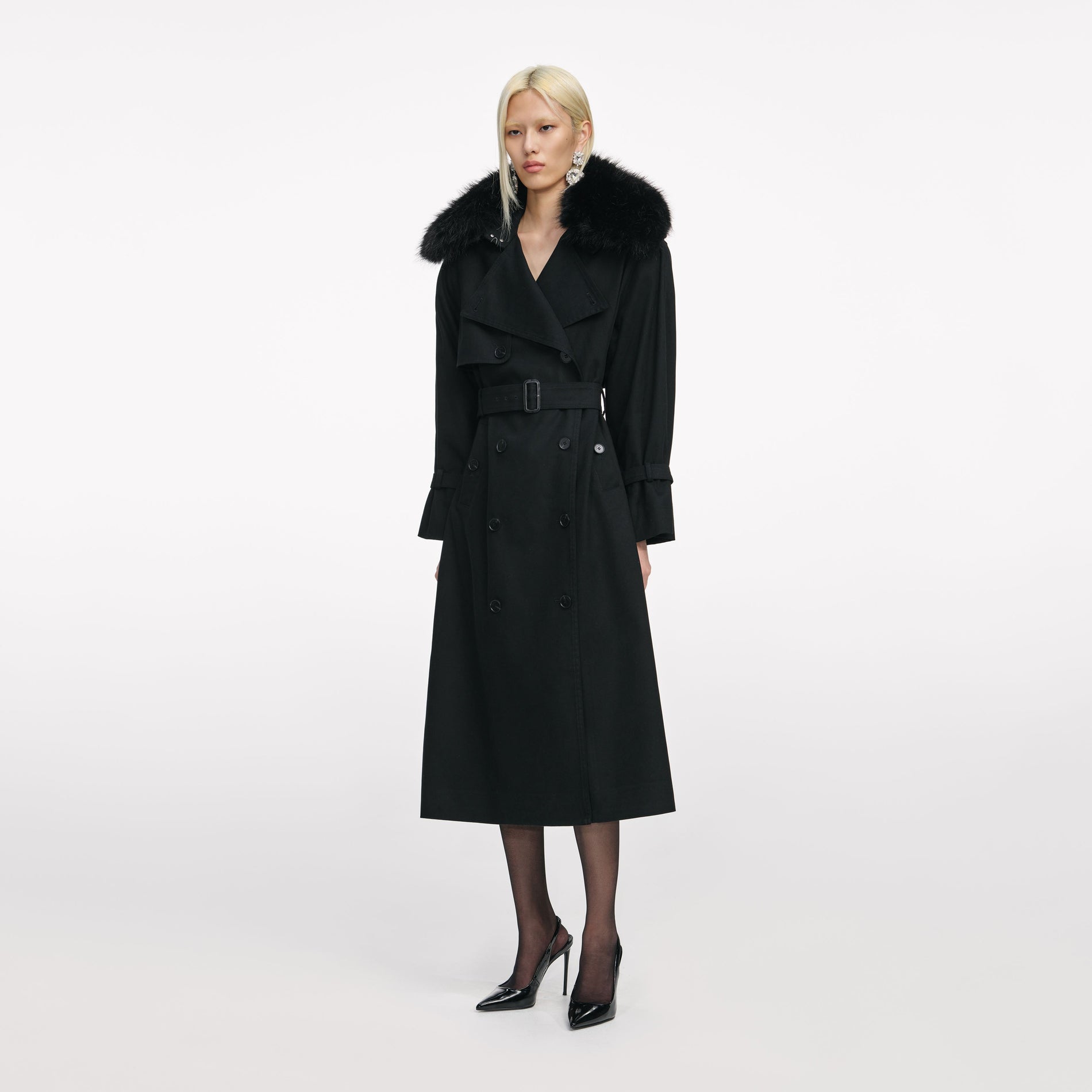 Side view of a woman wearing the Black Twill Fur Collar Trench Coat