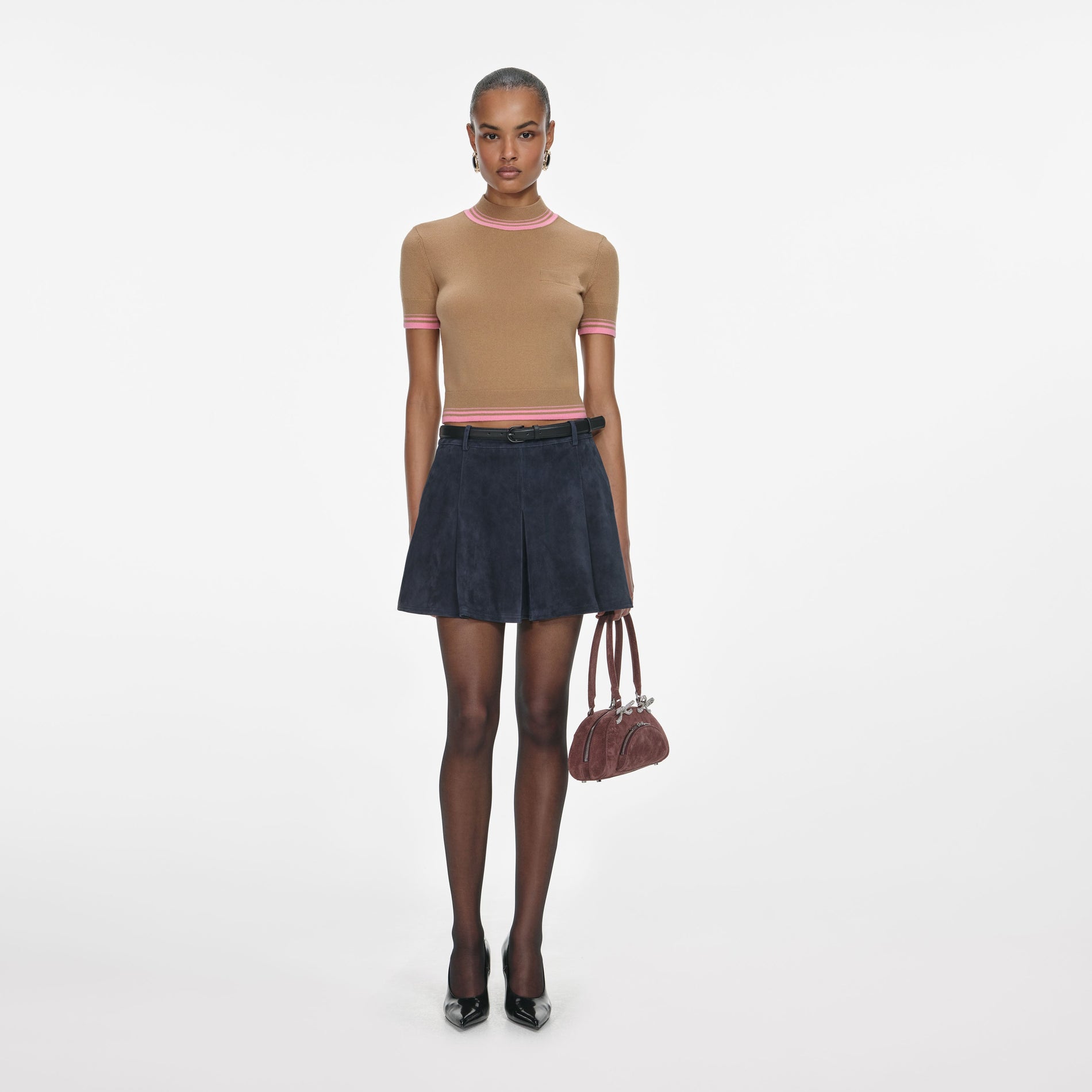 Front view of a woman wearing the Navy Suede Mini Skirt