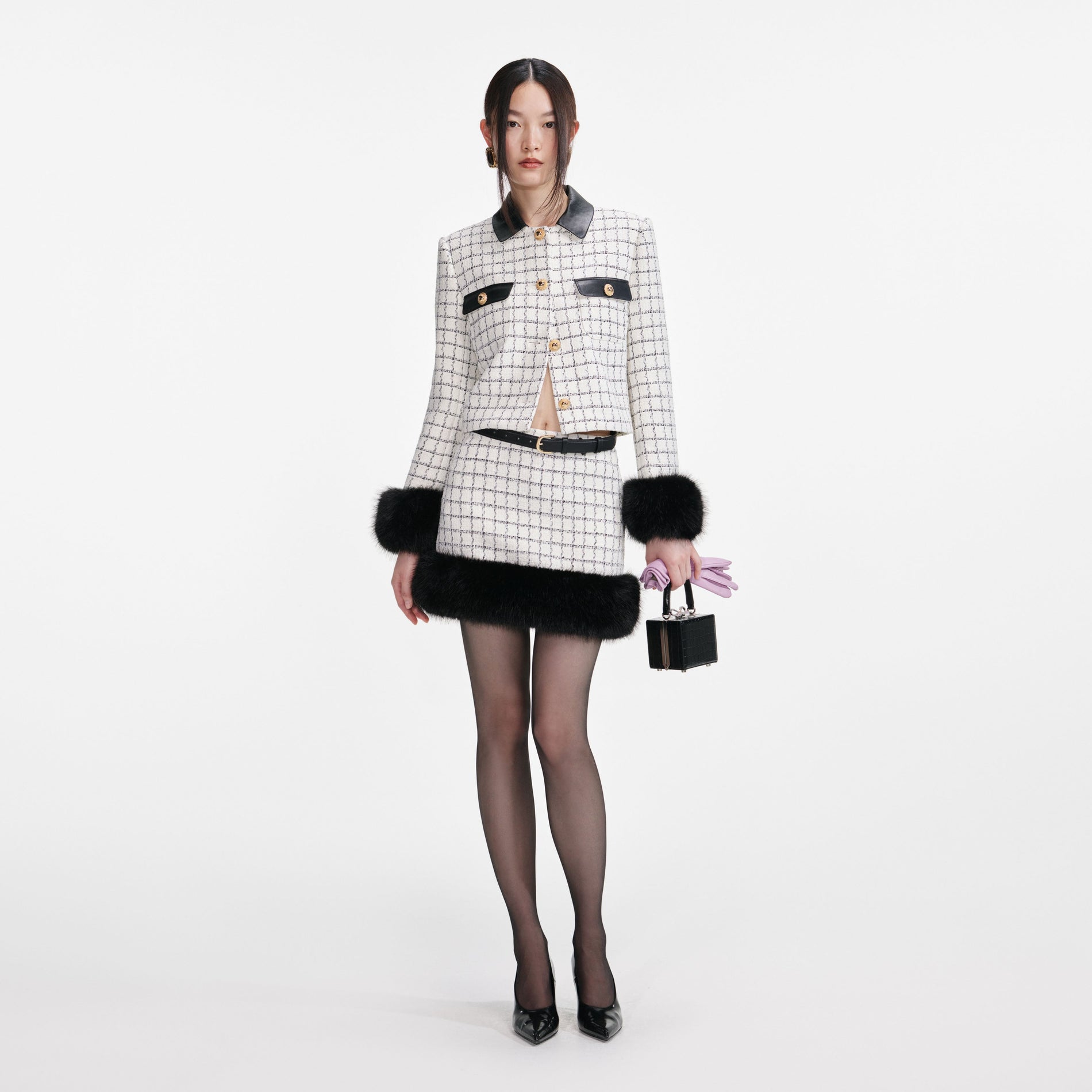Front view of a woman wearing the Check Boucle Fur Hem Mini Skirt