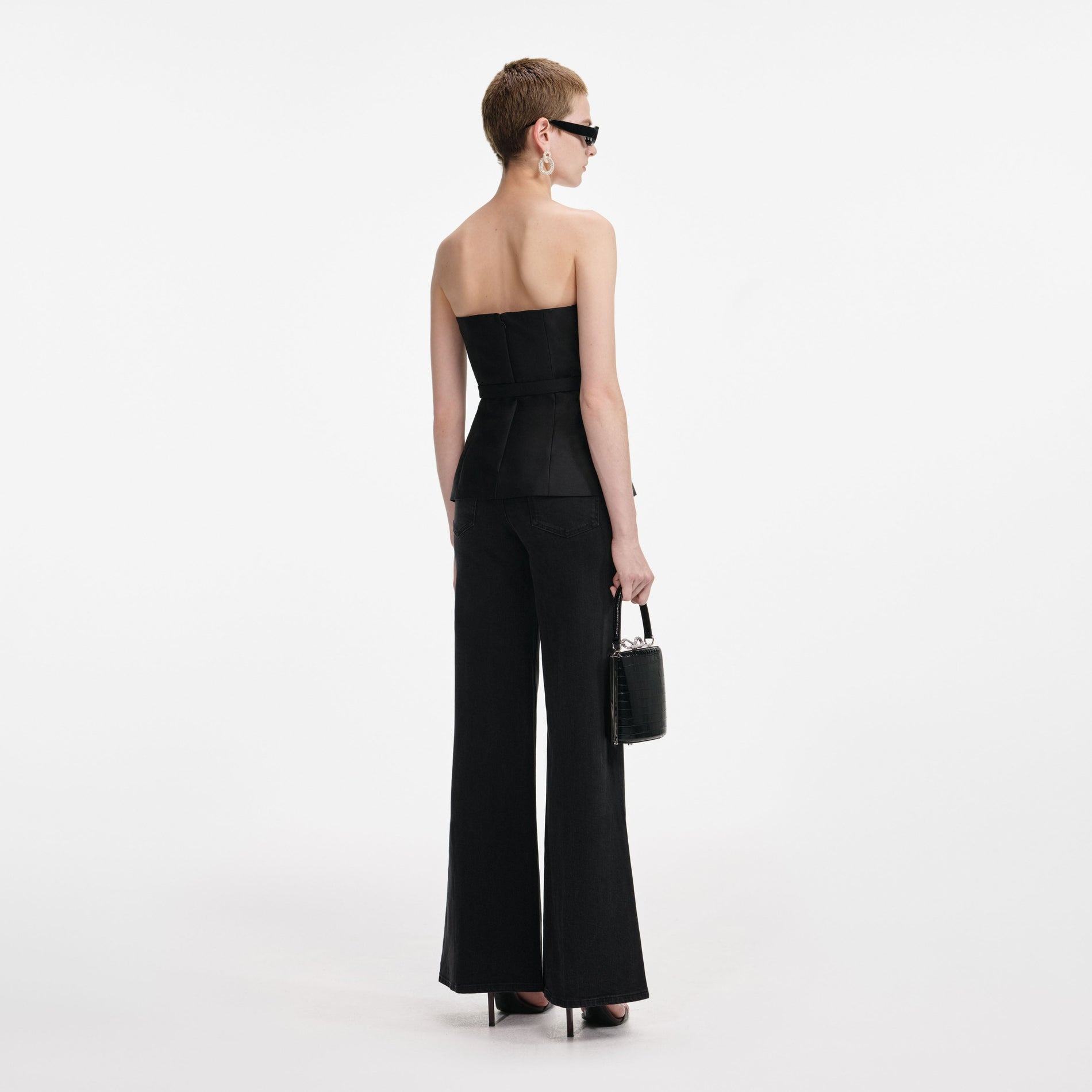 Back view of a woman wearing the Black Taffeta Bandeau Jumpsuit