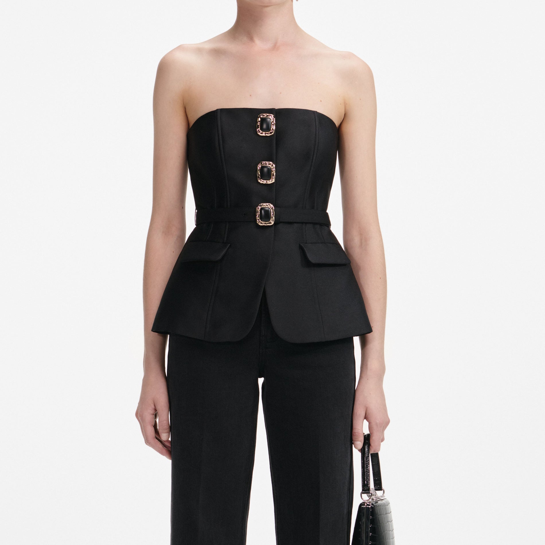 A close up of a woman wearing the Black Taffeta Bandeau Jumpsuit