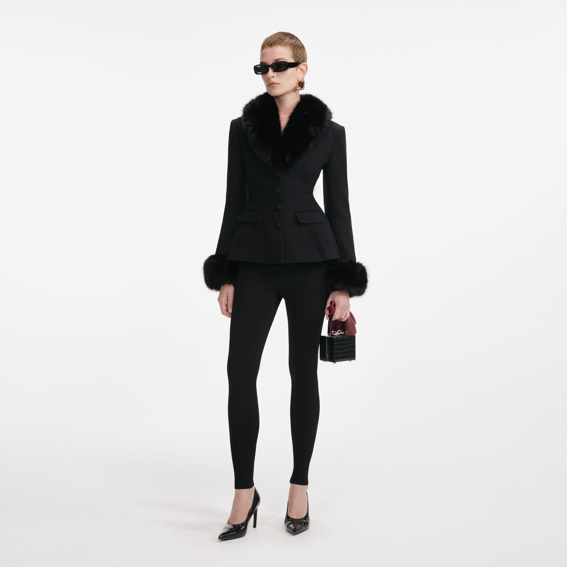 Side view of a woman wearing the Black Tailored Boucle Fur Jacket