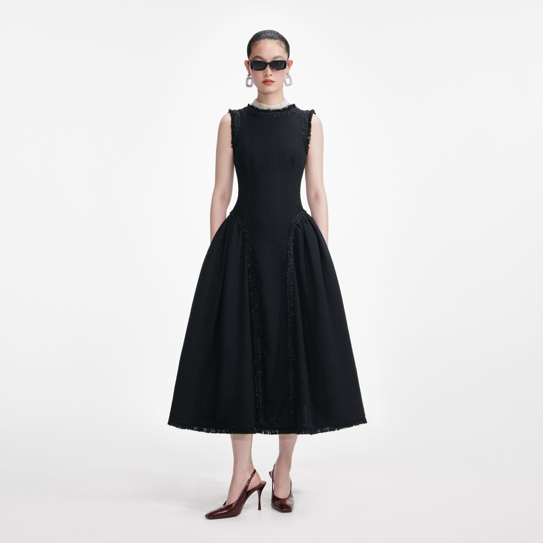 Front view of a woman wearing the Black Boucle Sleeveless Midi Dress