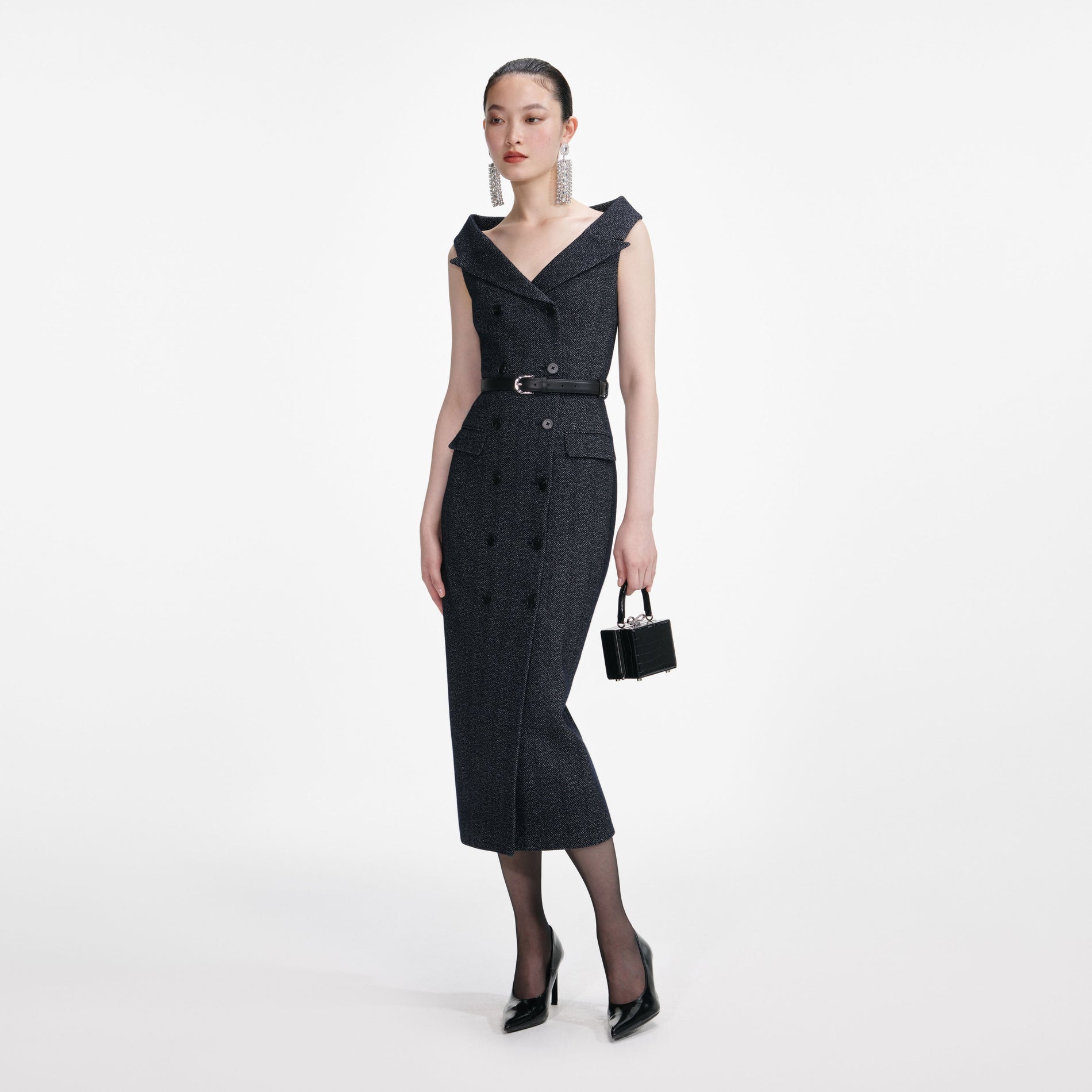 Side view of a woman wearing the Navy Herringbone Wool Midi Dress