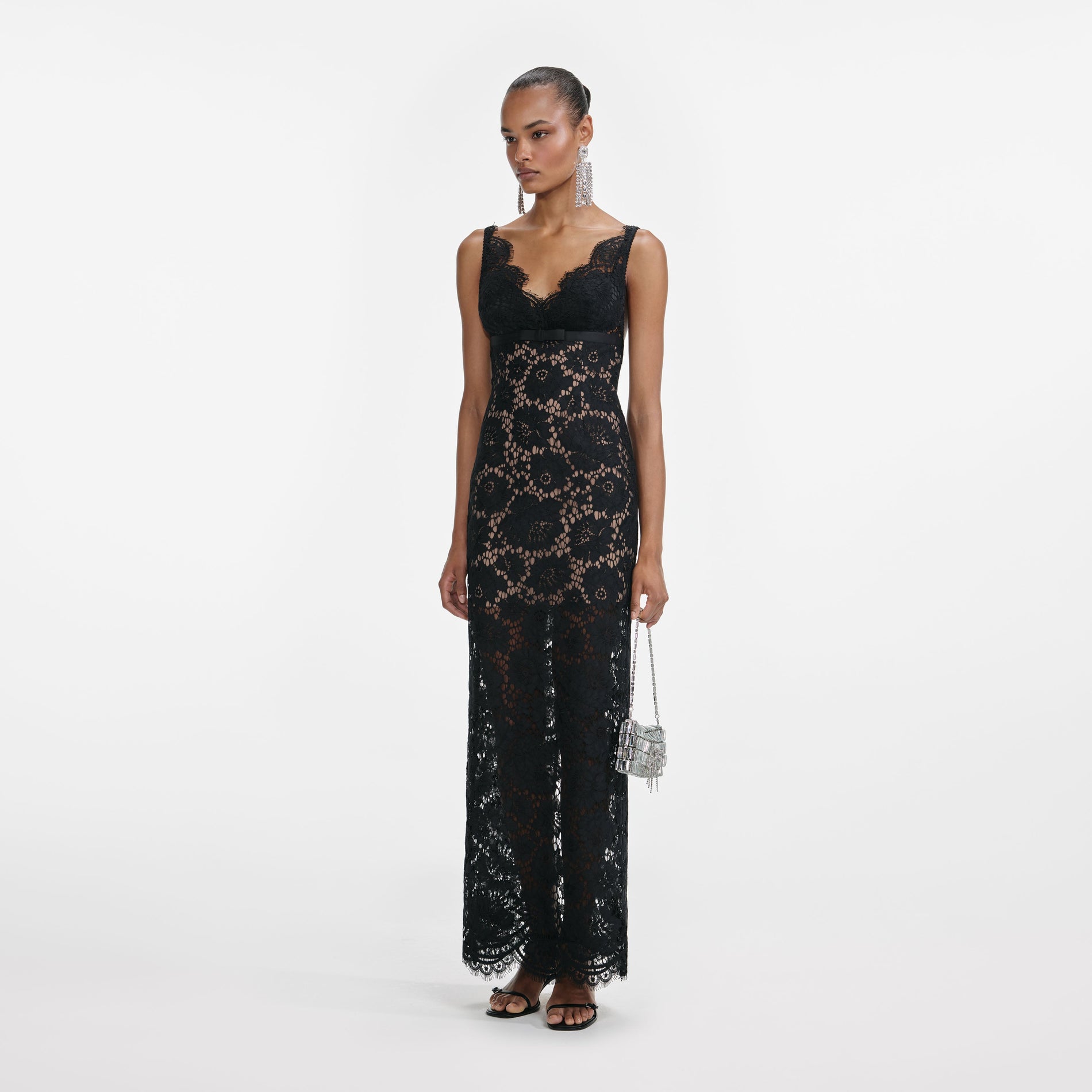 Side view of a woman wearing the Black Floral Lace Maxi Dress