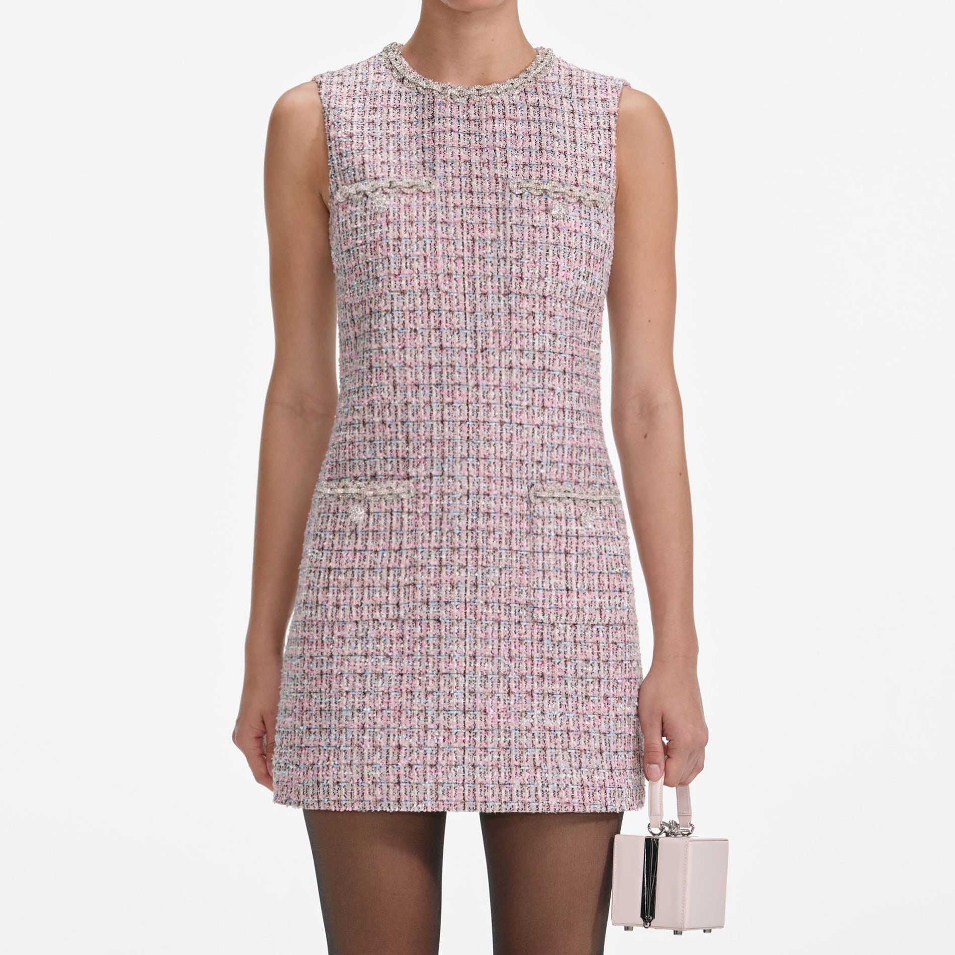 A close up of a woman wearing the Pink Boucle Sleeveless Mini Dress