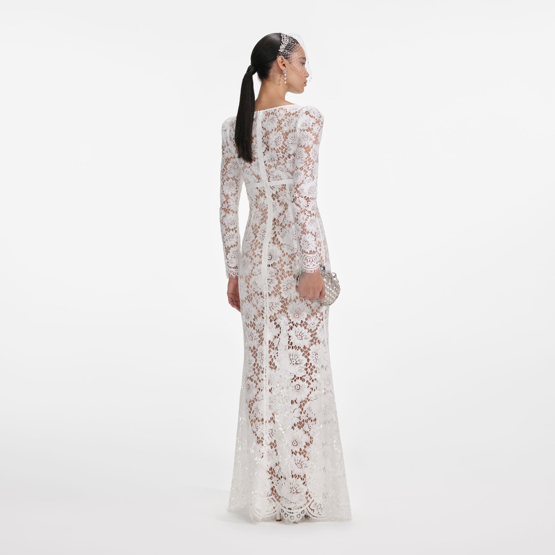 Back view of a woman wearing the White Floral Lace Maxi Dress