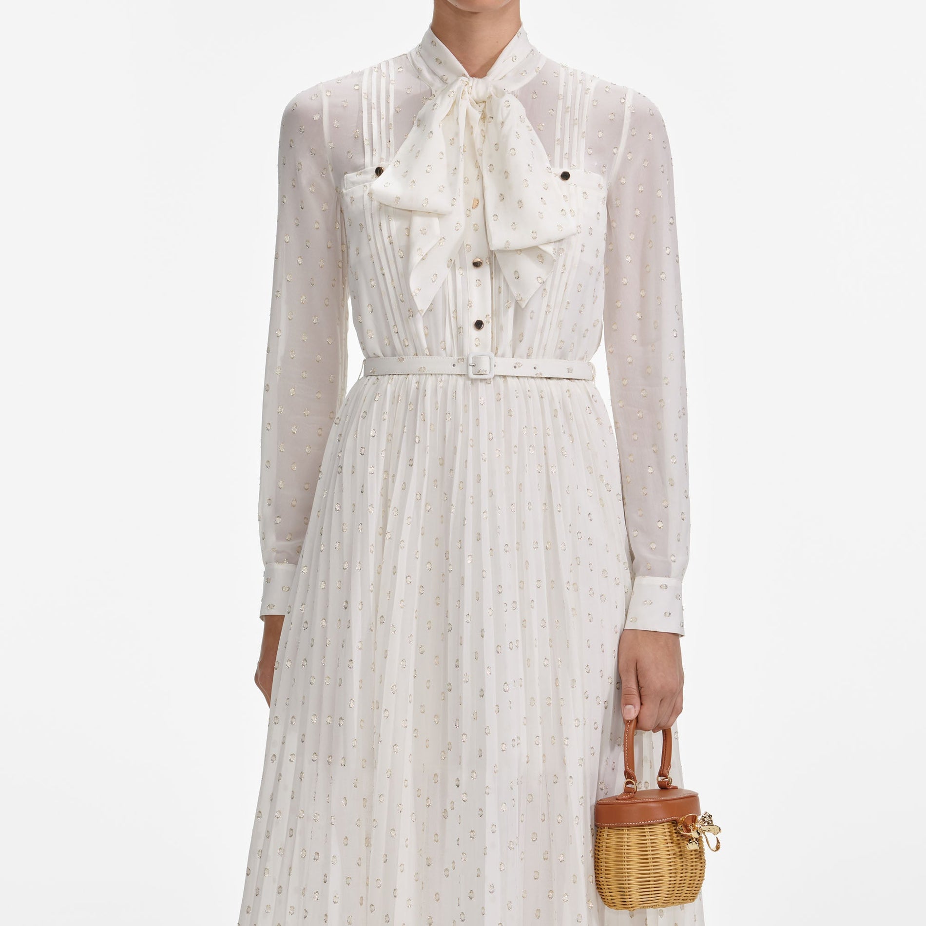 A close up of a woman wearing the Cream And Gold Pussy Bow Midi Dress