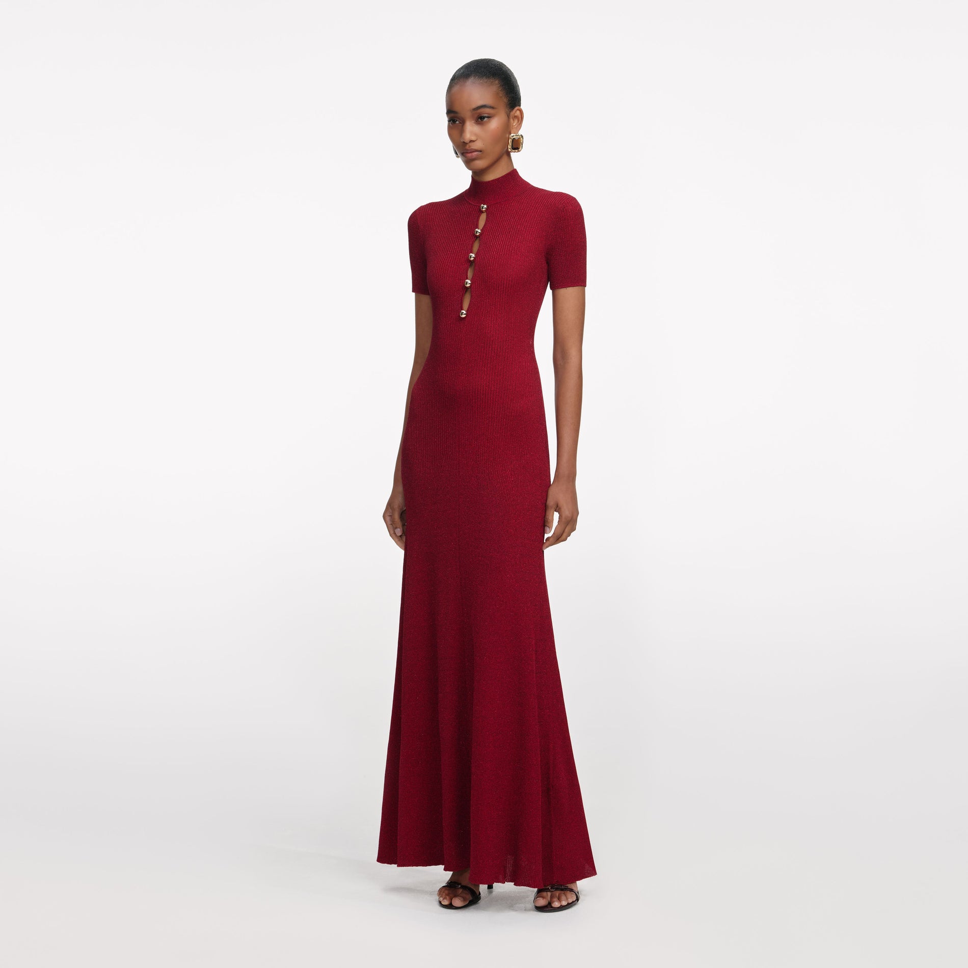 Side view of a woman wearing the Red Lurex Knit Maxi Dress