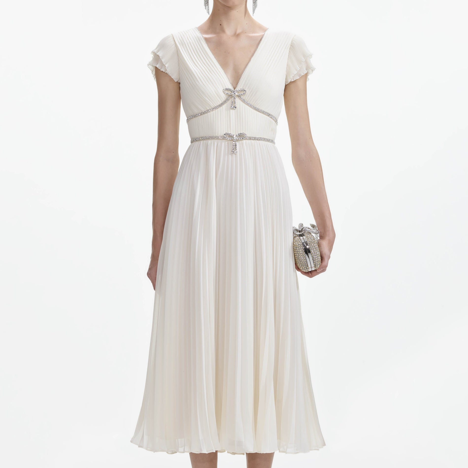 A close up of a woman wearing the Cream Chiffon Pleated Midi Dress