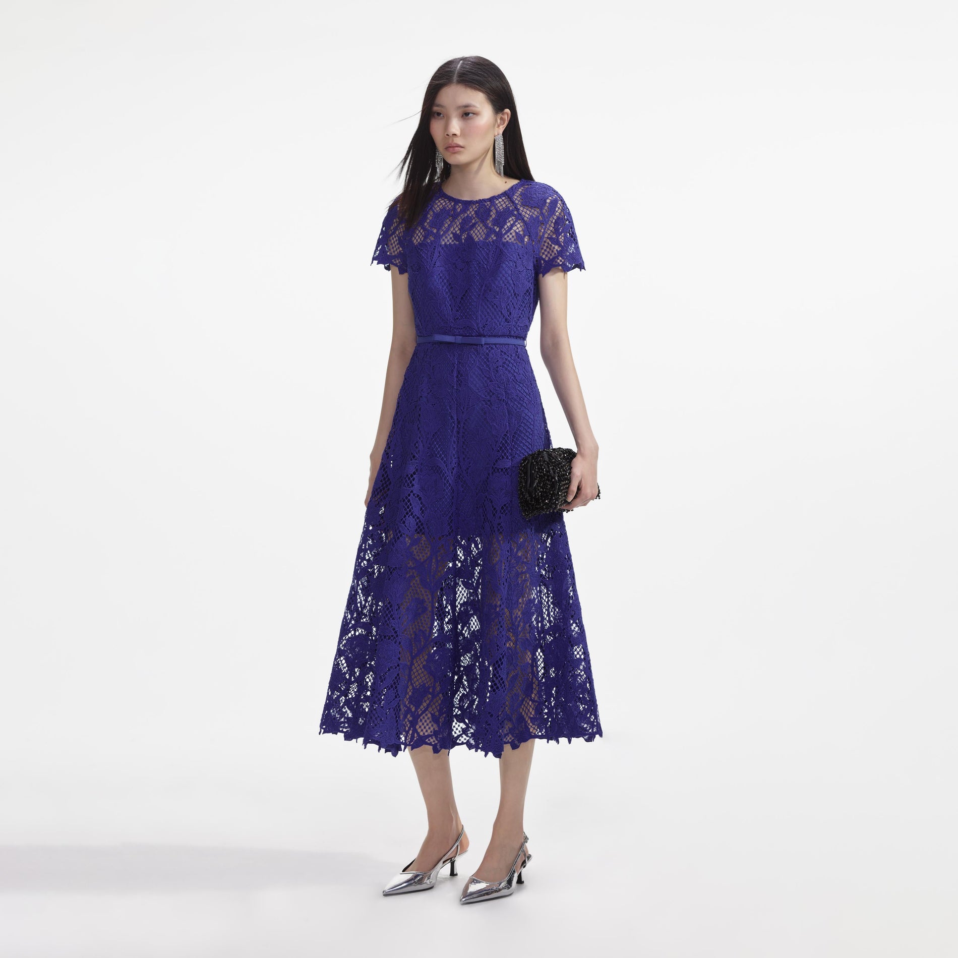 Side view of a woman wearing the Cobalt Lace Midi Dress