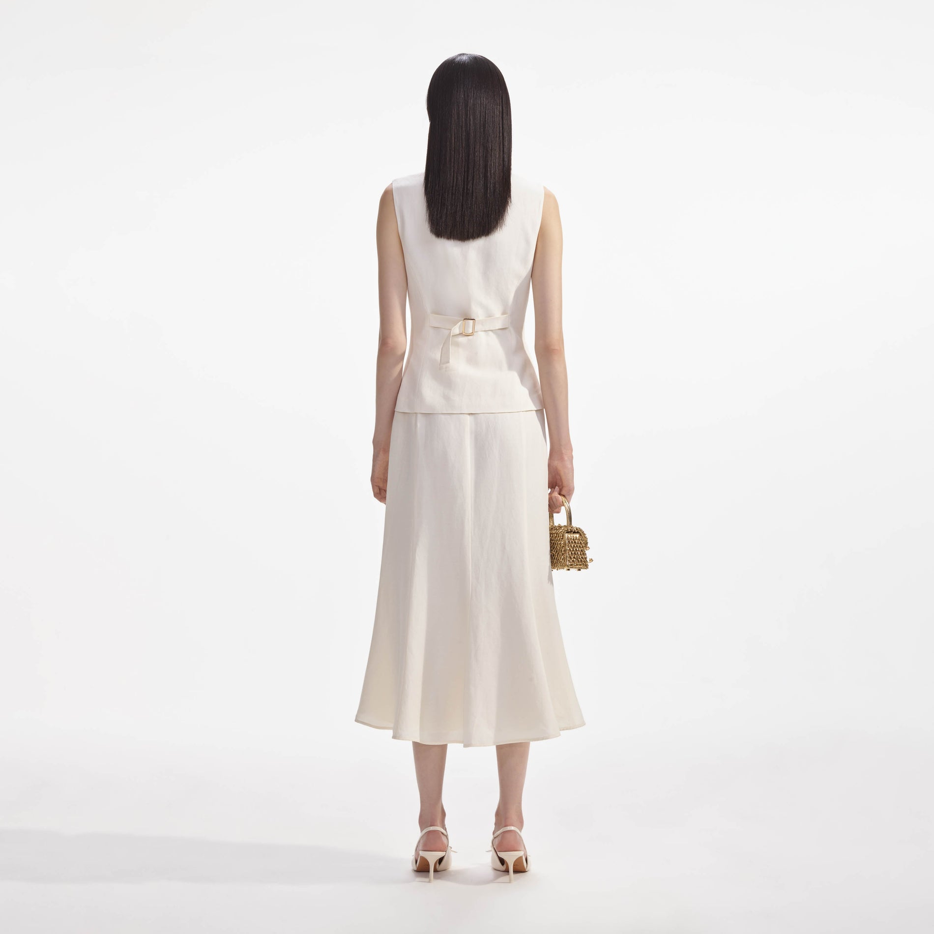 Back view of a woman wearing the Cream Linen Midi Dress