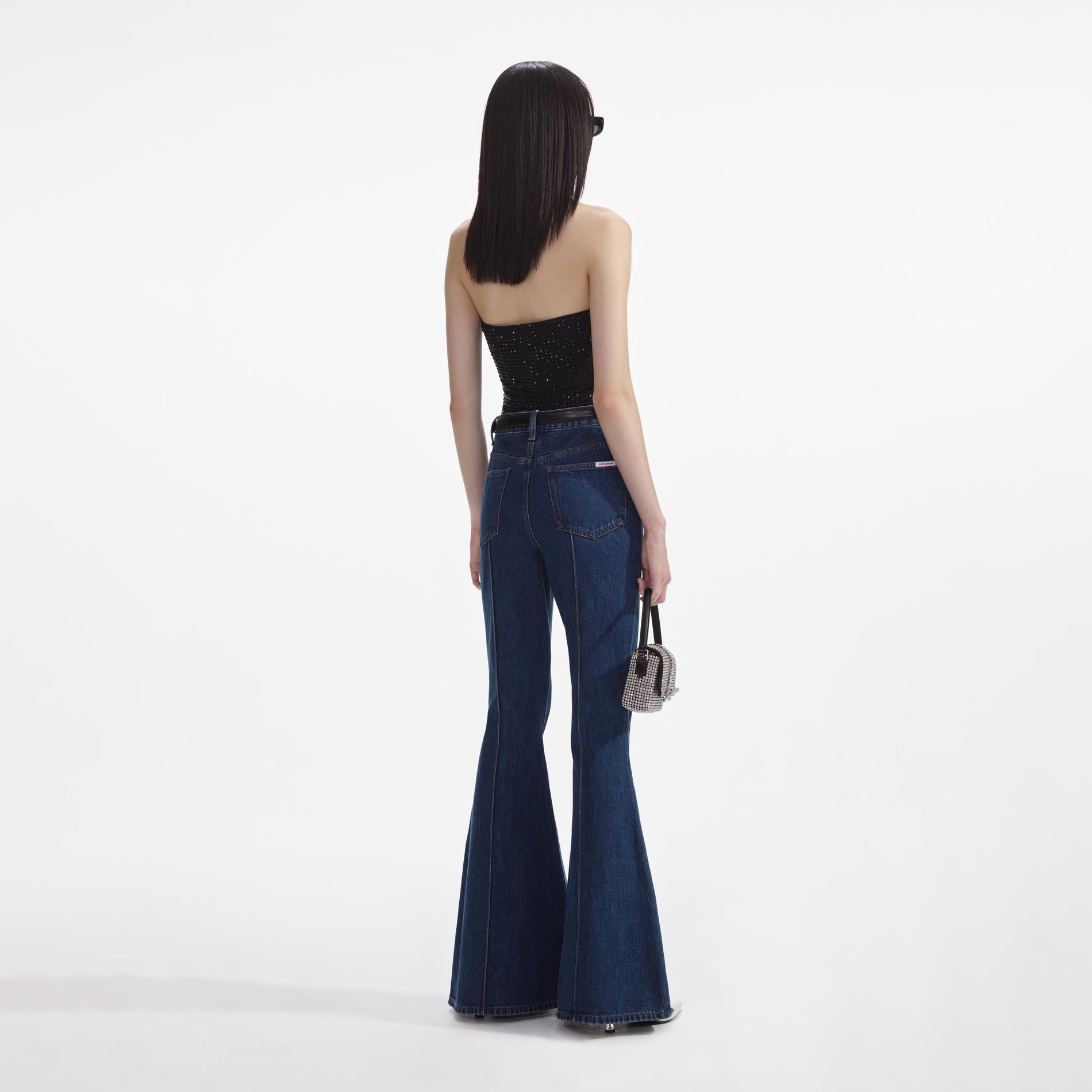Back view of a woman wearing the Denim Kick Flare Jeans