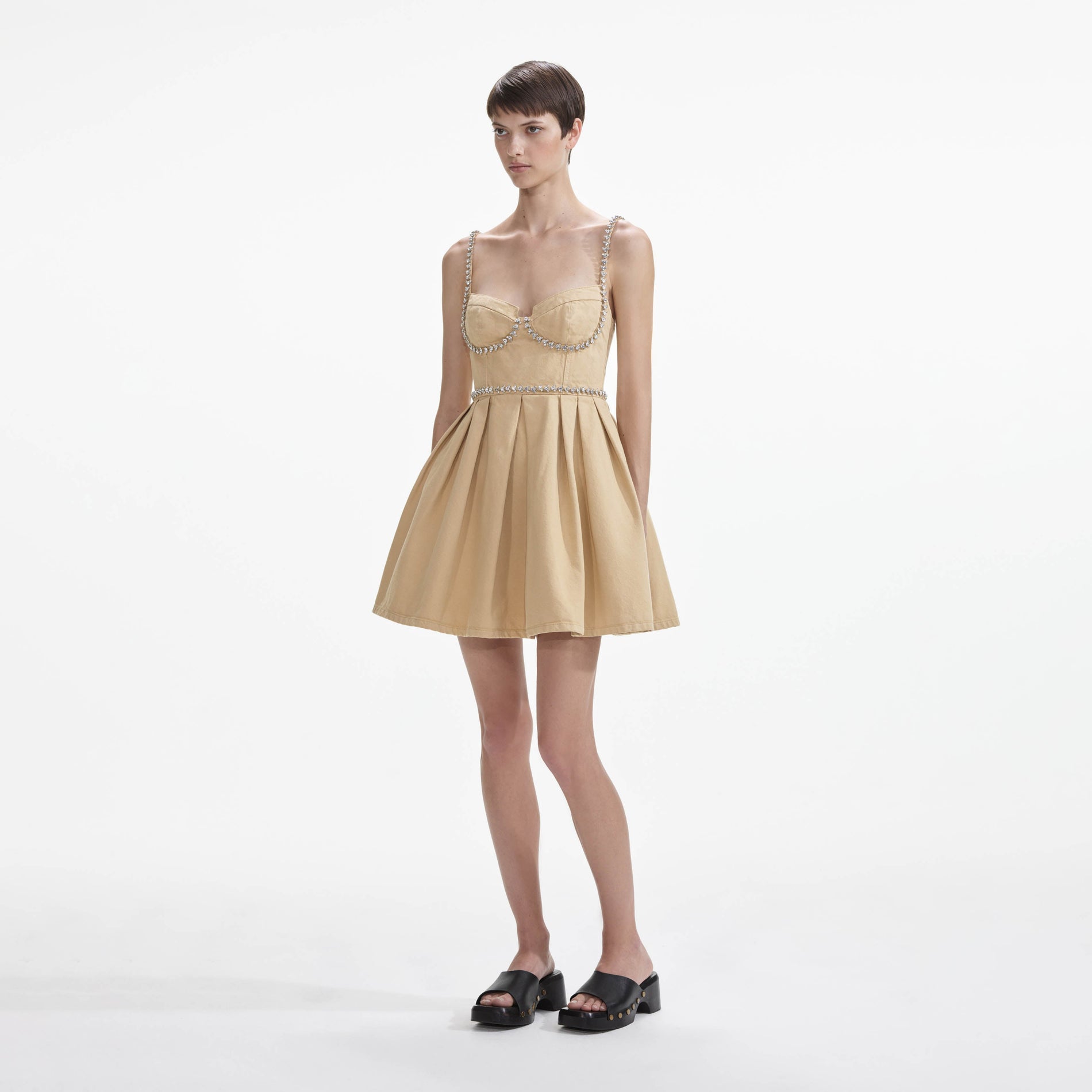 Side view of a woman wearing the Beige Diamante Denim Mini Dress