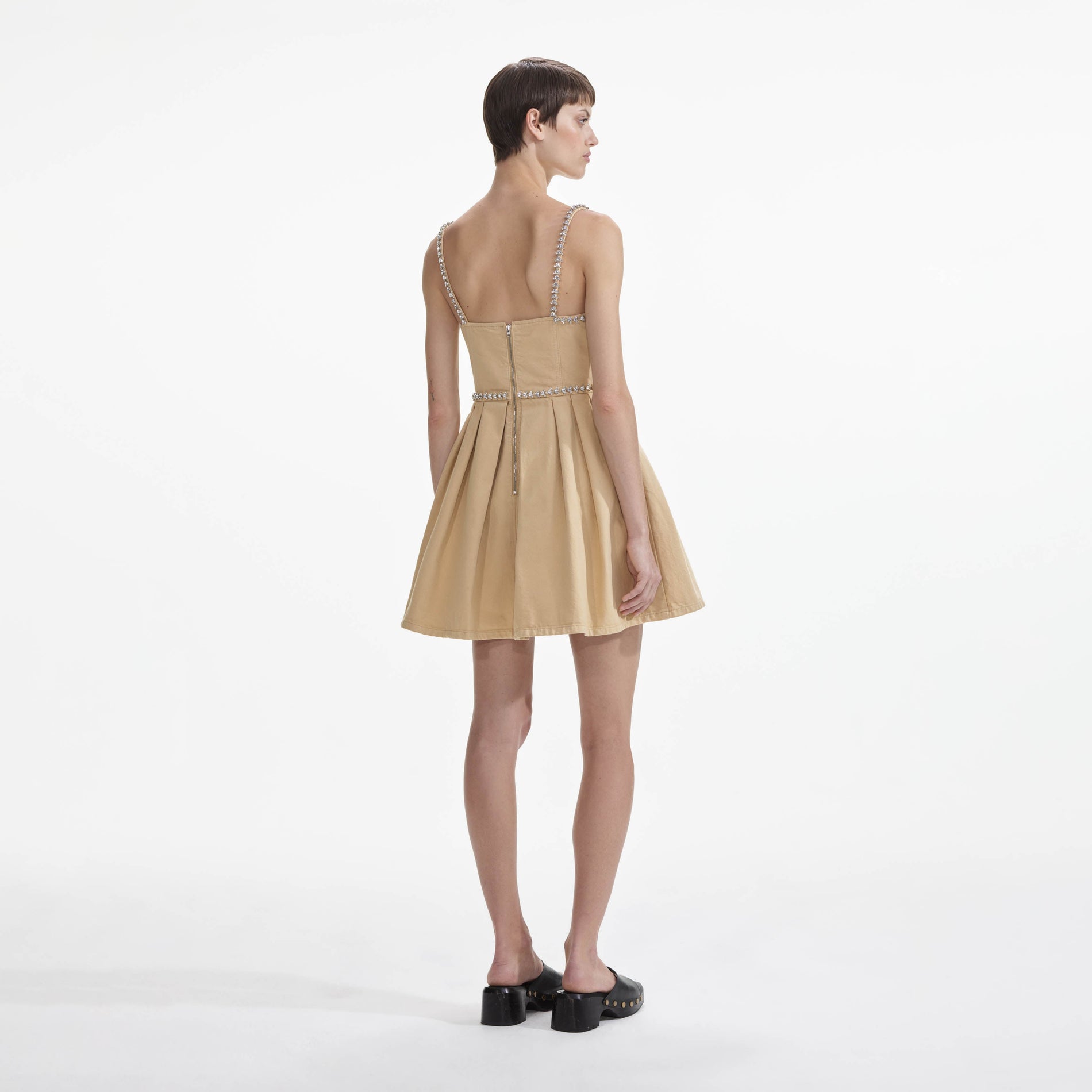 Back view of a woman wearing the Beige Diamante Denim Mini Dress