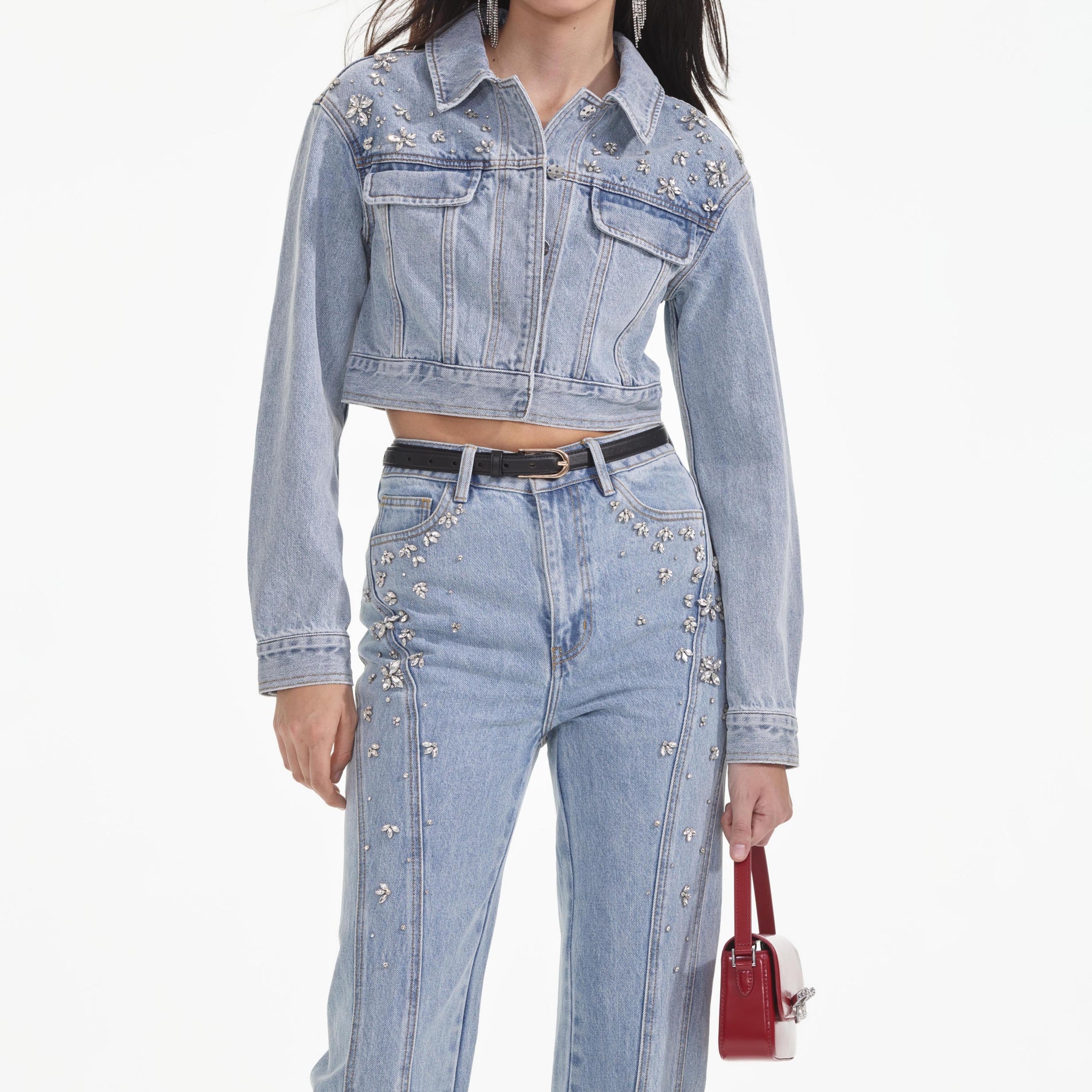 A close up of a woman wearing the Crystal Embellished Denim Jacket