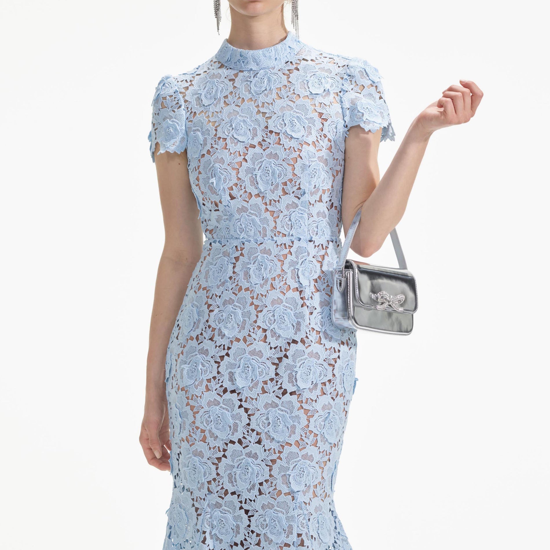 A close up of a woman wearing the Blue Flower Lace Midi Dress