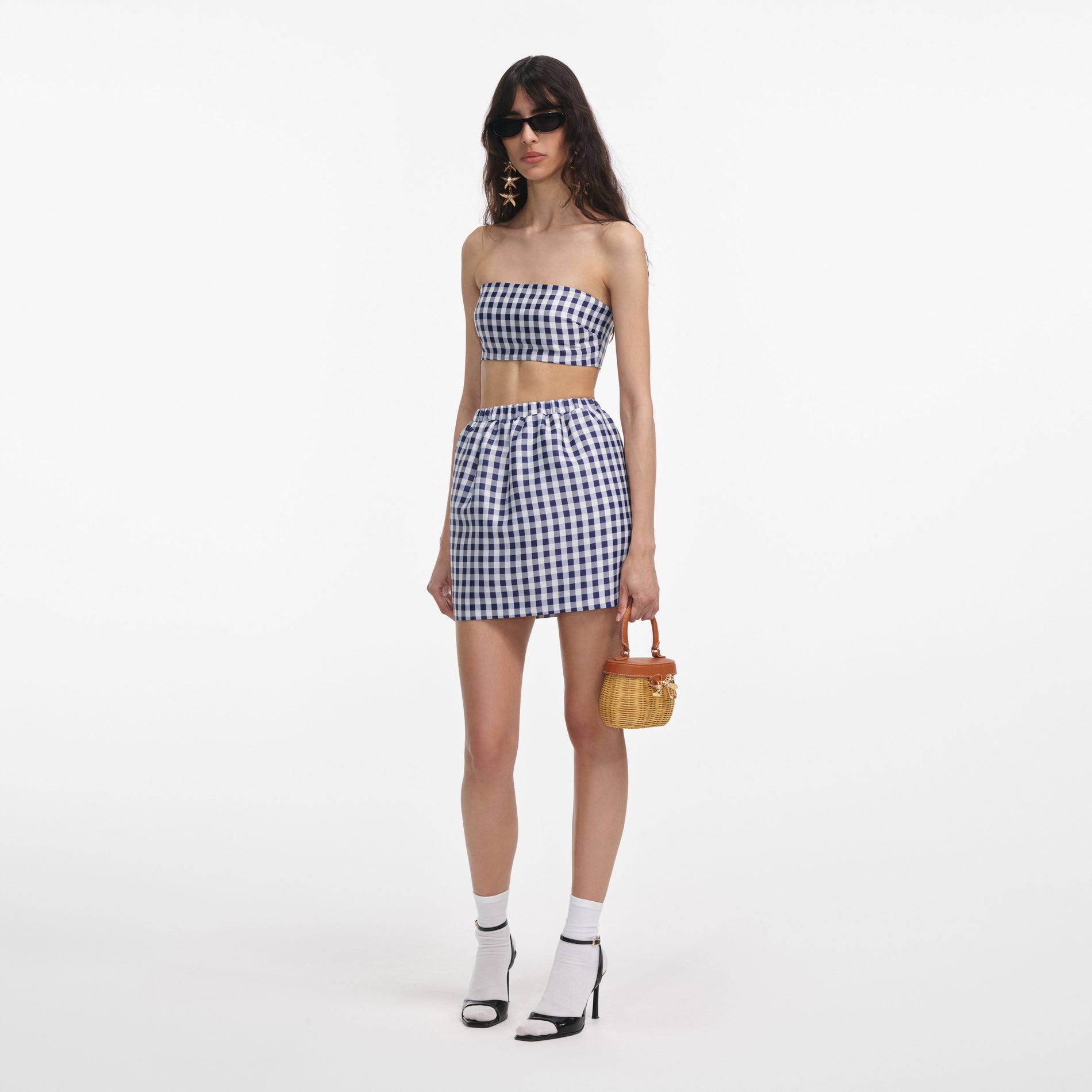 Side view of a woman wearing the Navy Gingham Taffeta Mini Skirt