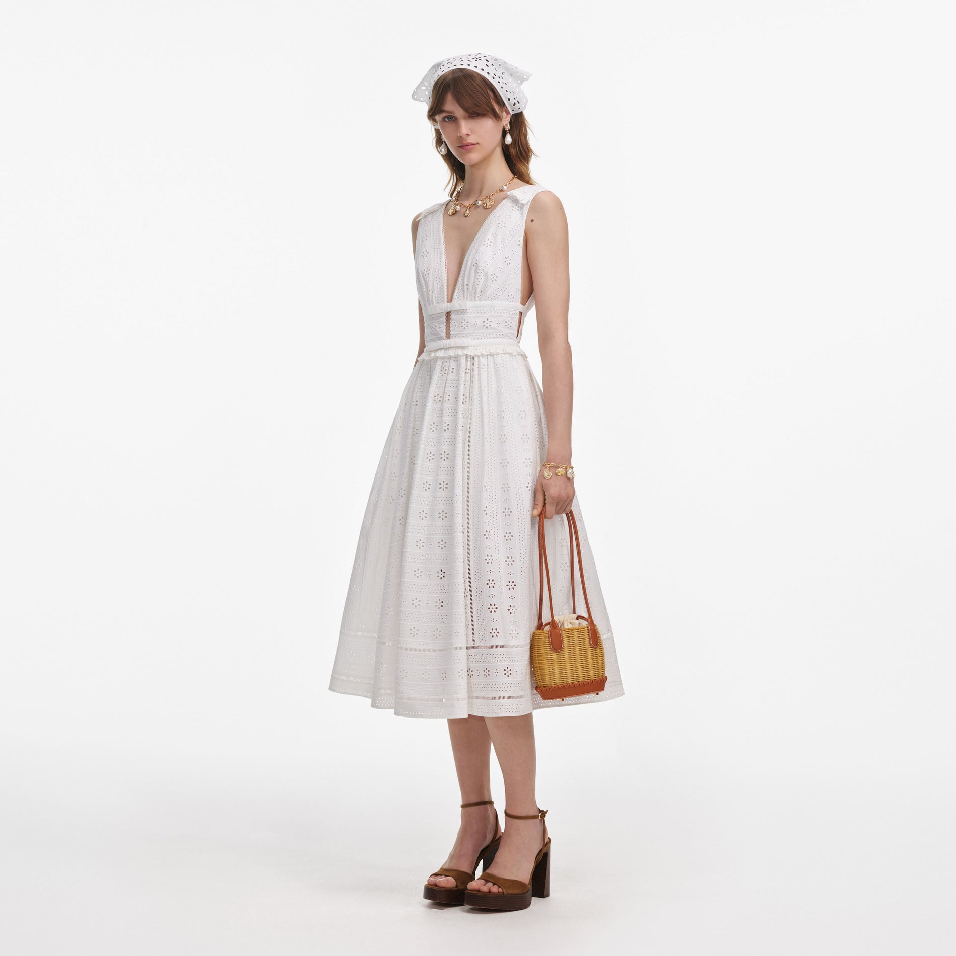 Side view of a woman wearing the White Cotton Broderie Midi Dress