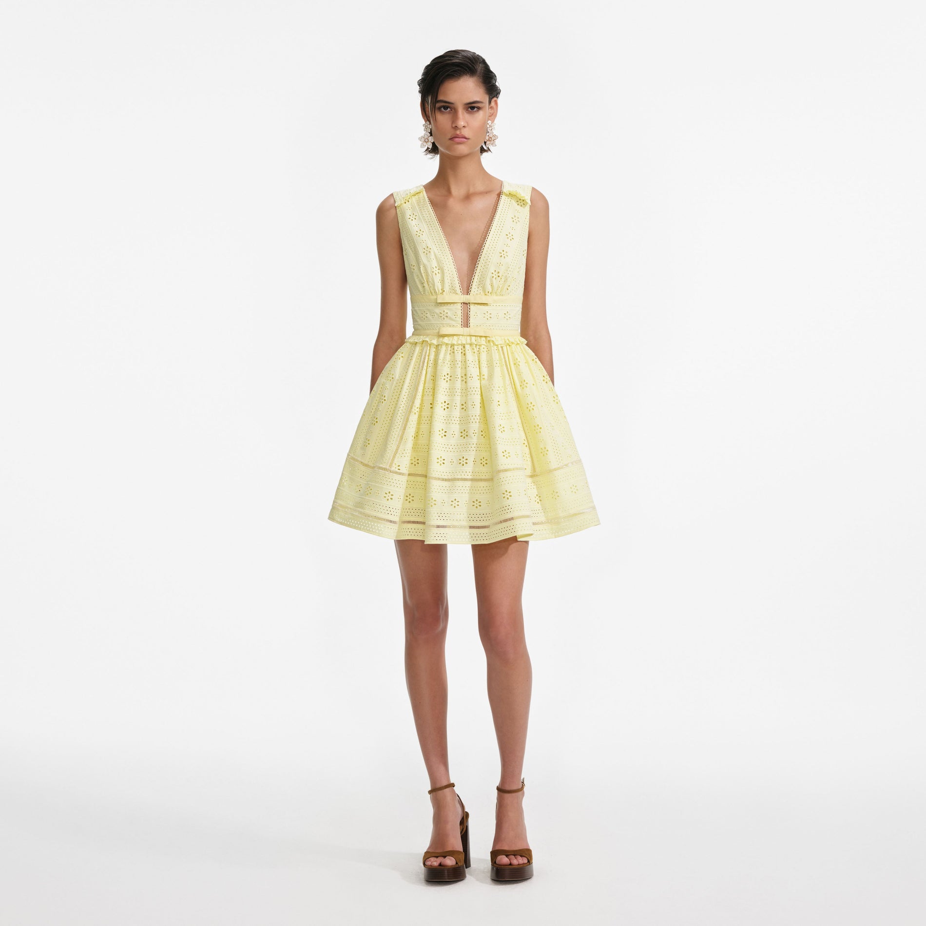 Front view of a woman wearing the Yellow Cotton Broderie Mini Dress