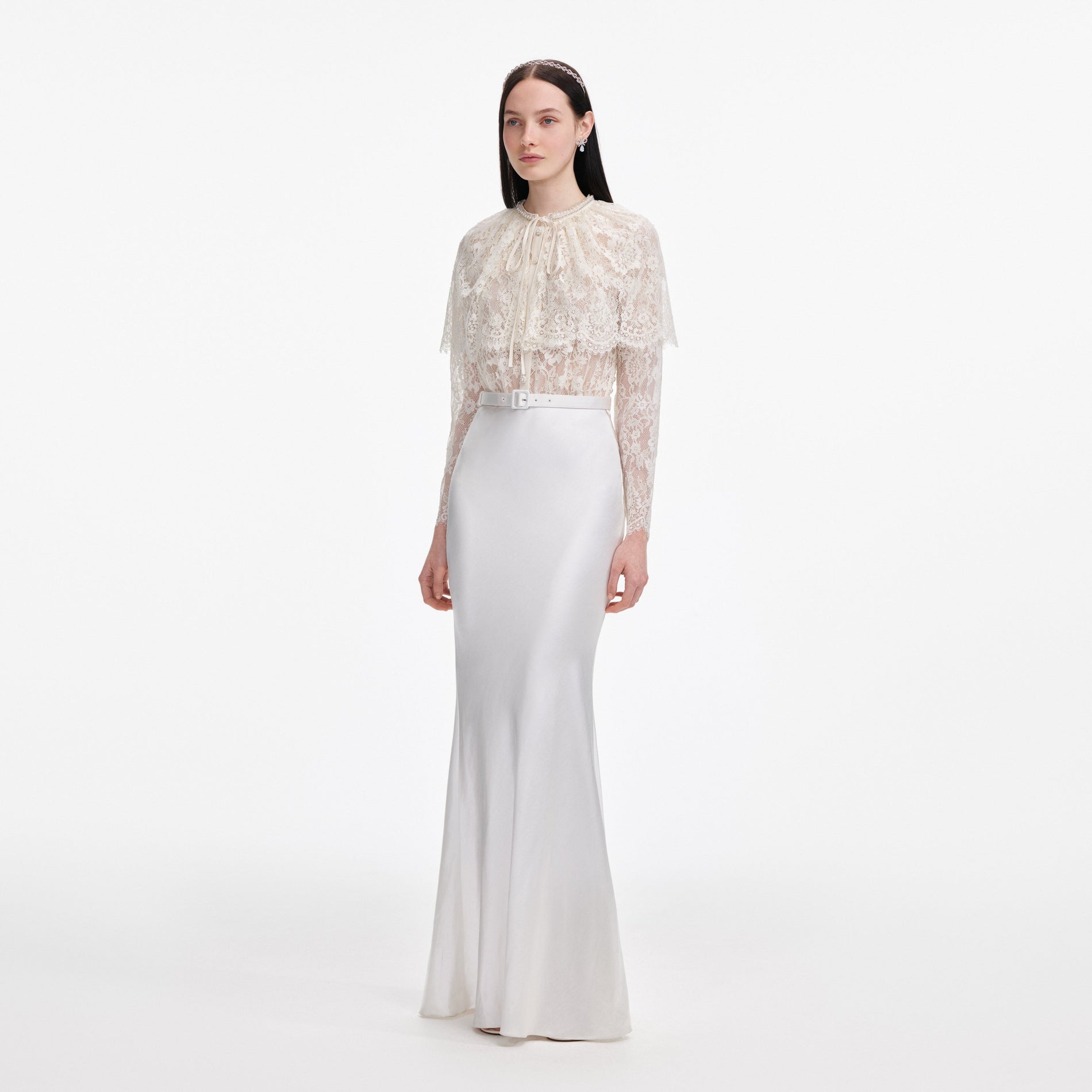 Side view of a woman wearing the White Lace Cape Maxi Dress