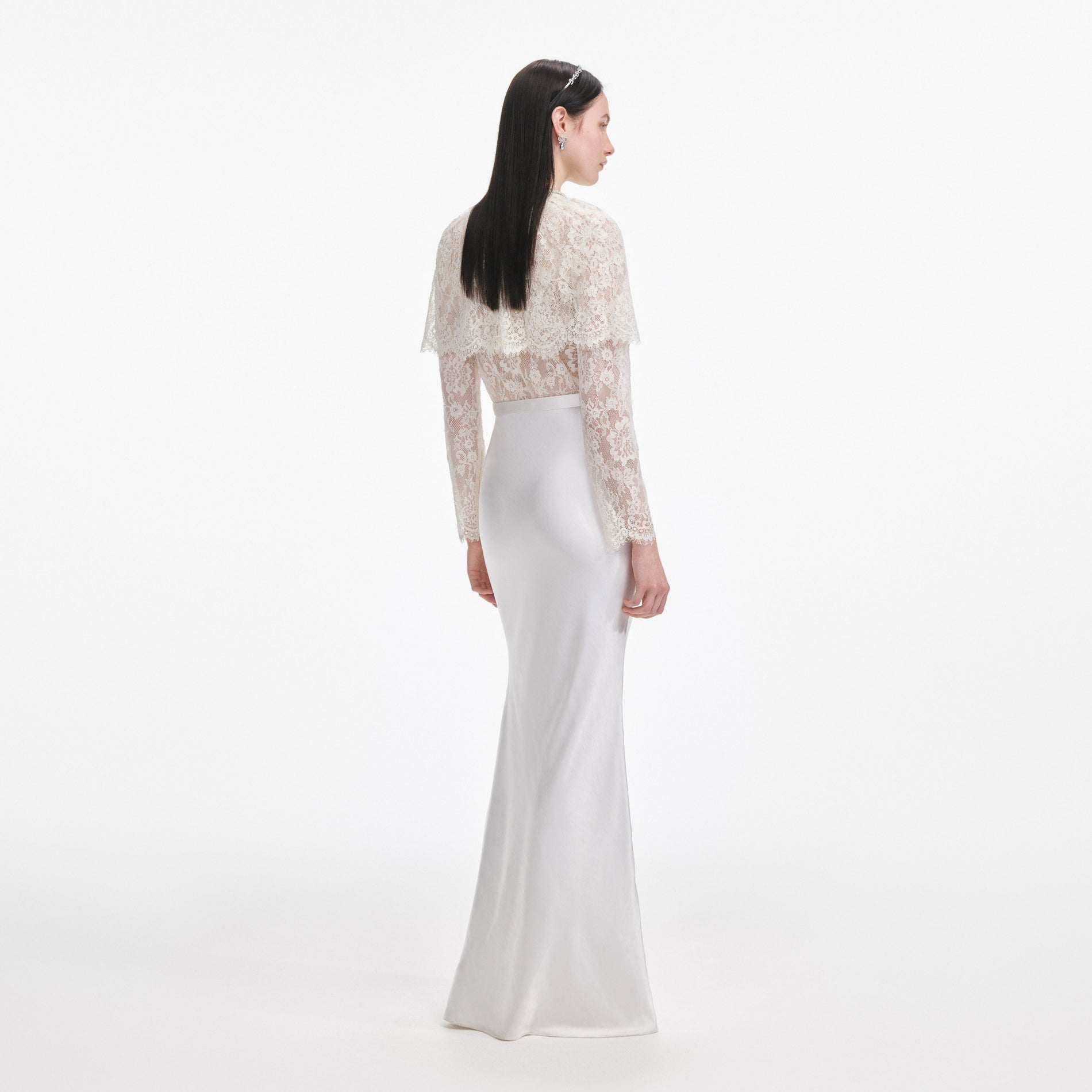 Back view of a woman wearing the White Lace Cape Maxi Dress