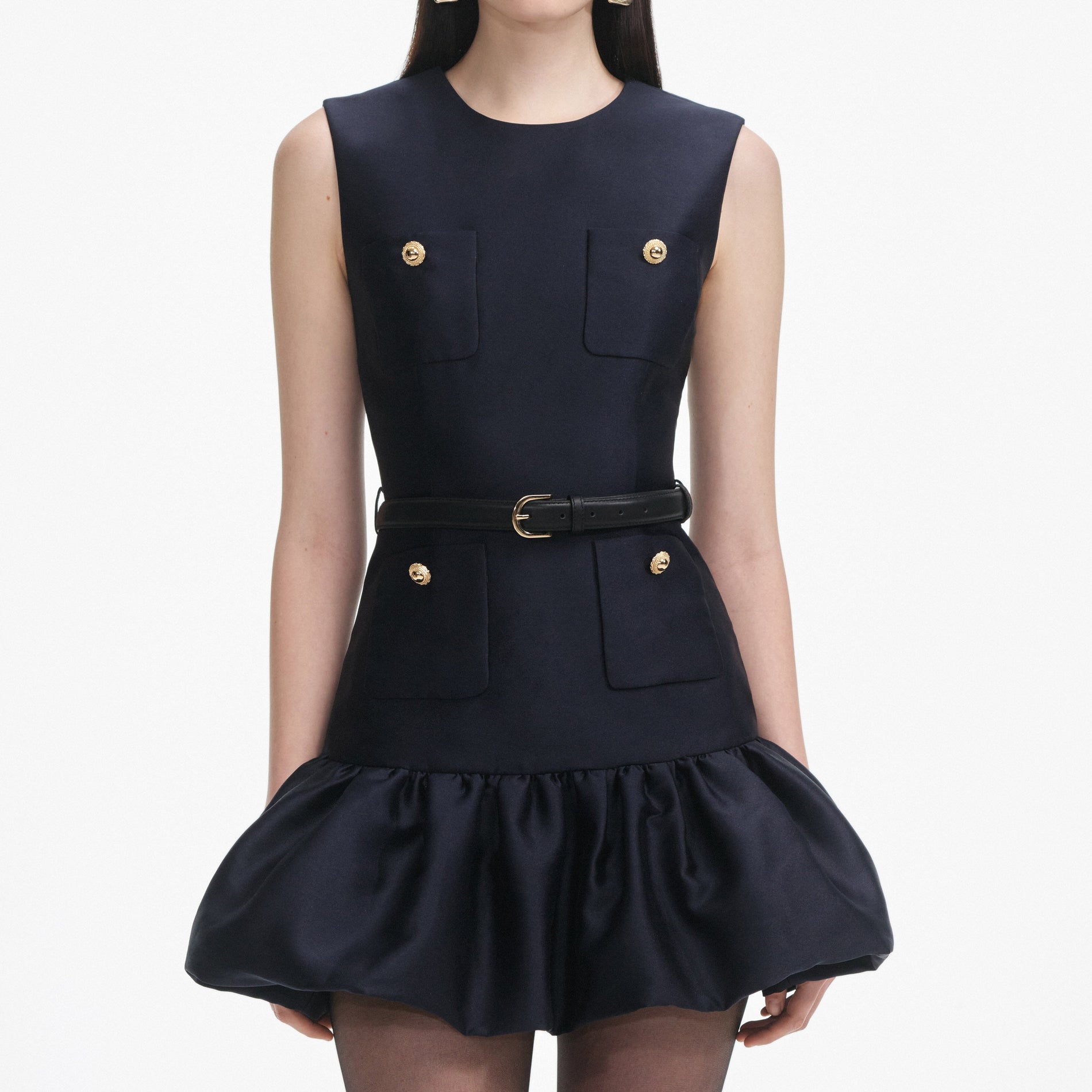 A close up of a woman wearing the Navy Taffeta Mini Dress