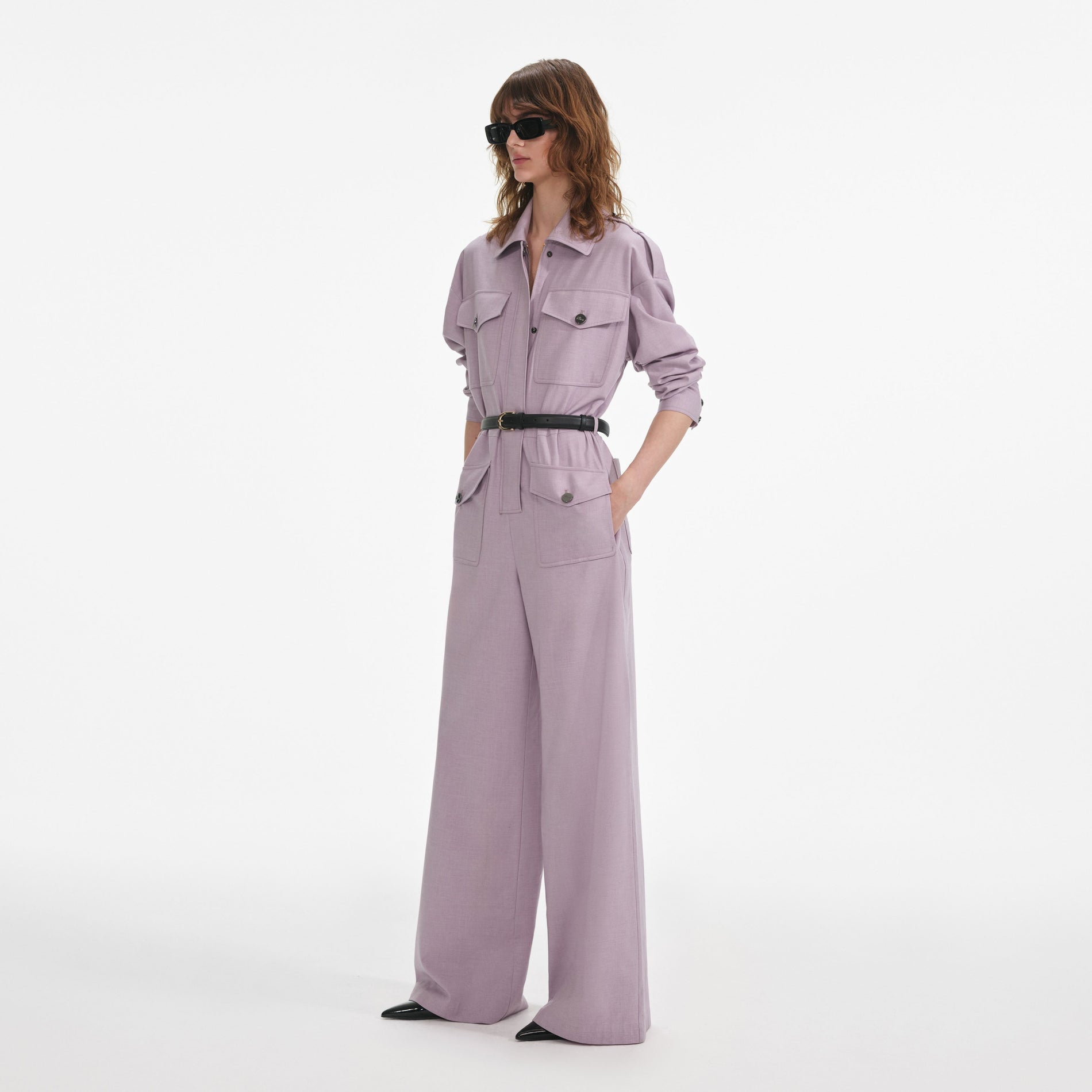 Side view of a woman wearing the Lilac Twill Jumpsuit