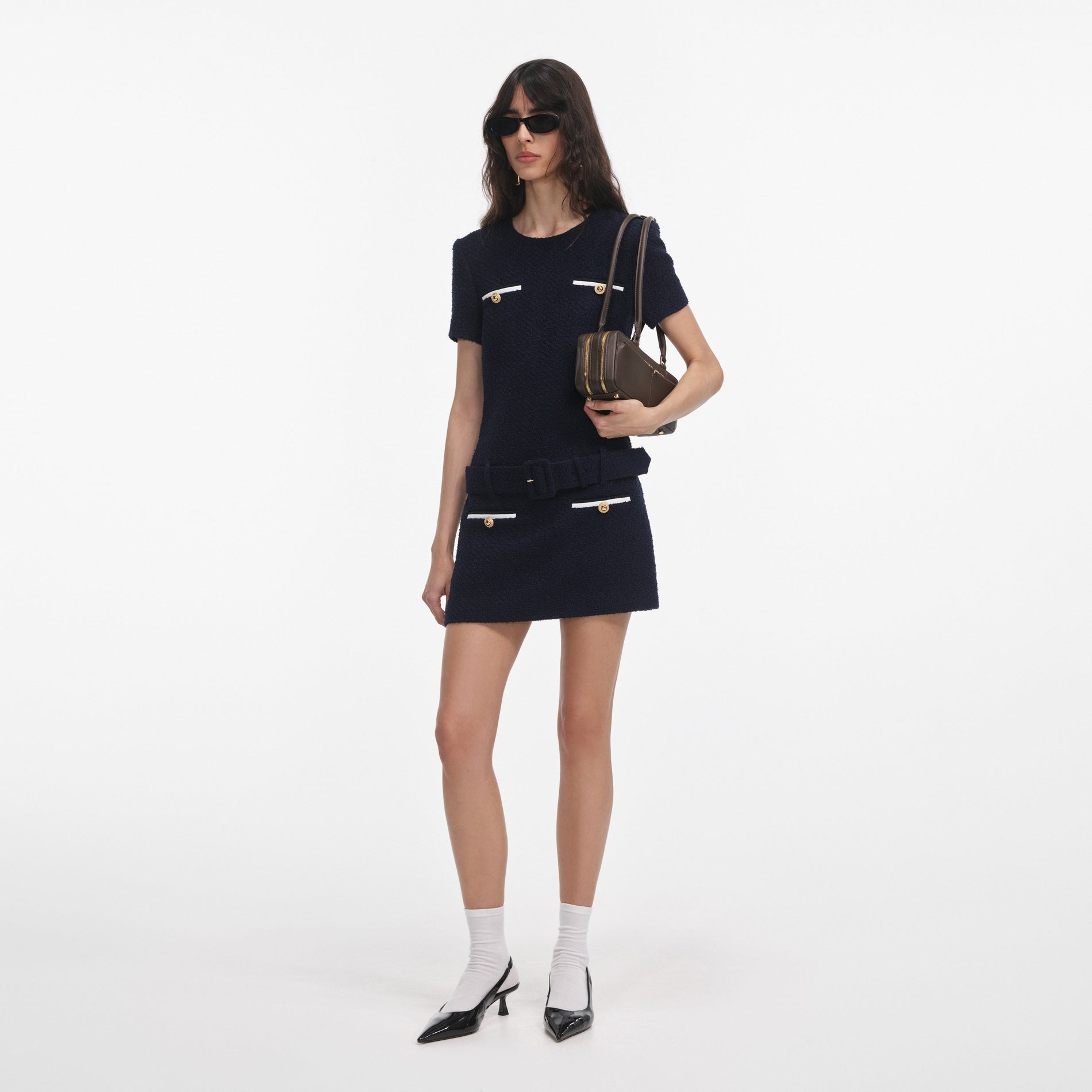 Side view of a woman wearing the Navy Boucle Mini Dress