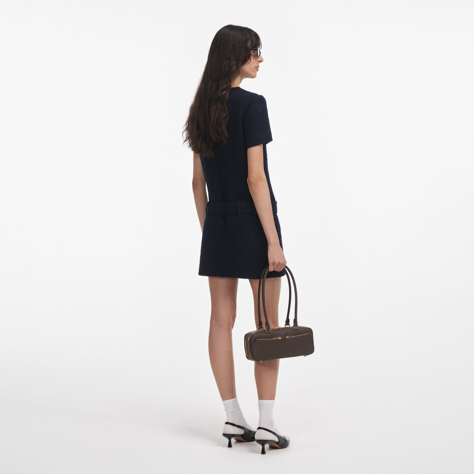 Back view of a woman wearing the Navy Boucle Mini Dress