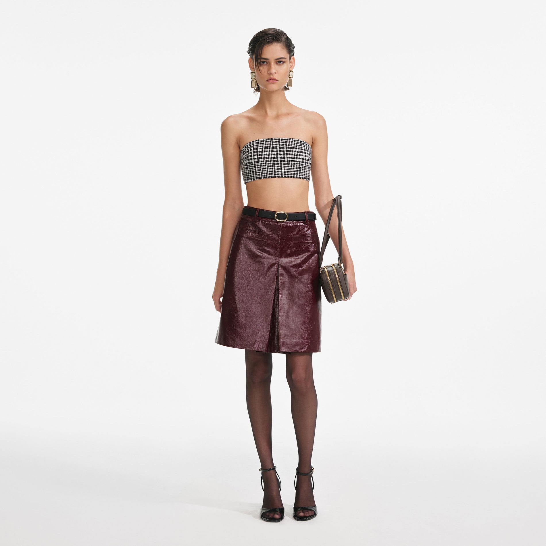 Front view of a woman wearing the Burgundy Leather Mini Skirt