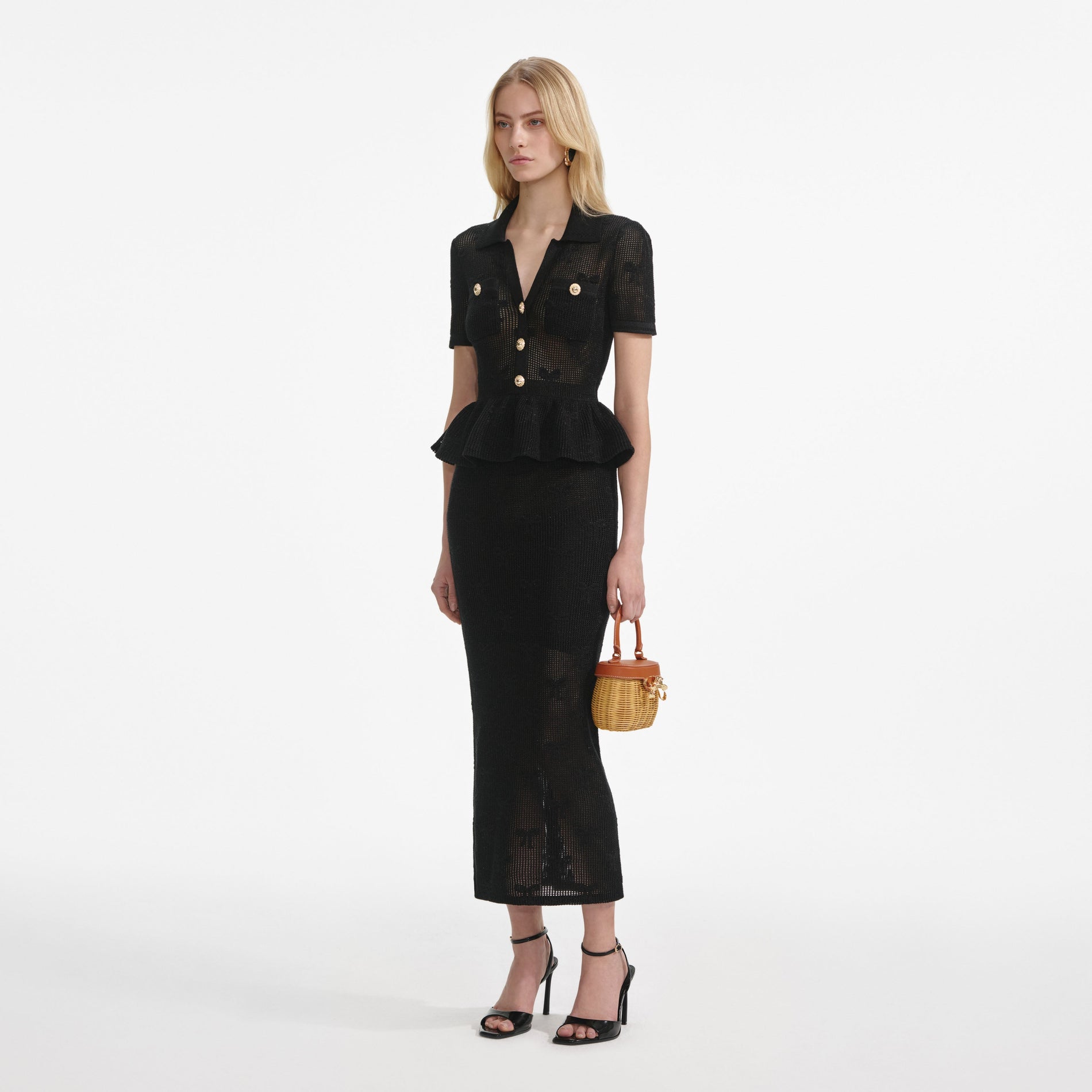 Side view of a woman wearing the Black Bow Crochet Midi Dress