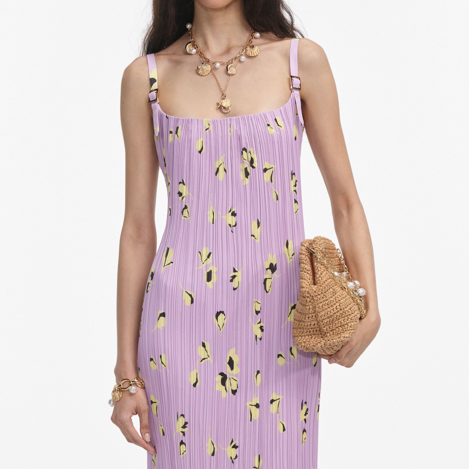 A close up of a woman wearing the Lilac Floral Plisse Midi Dress