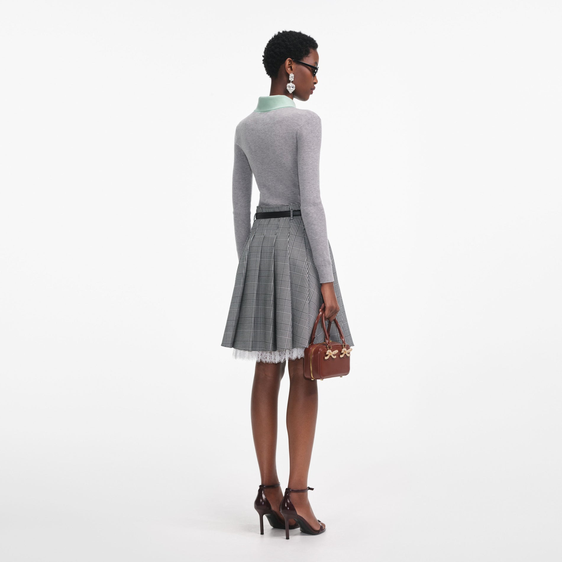 Back view of a woman wearing the Grey Merino Wool Cardigan