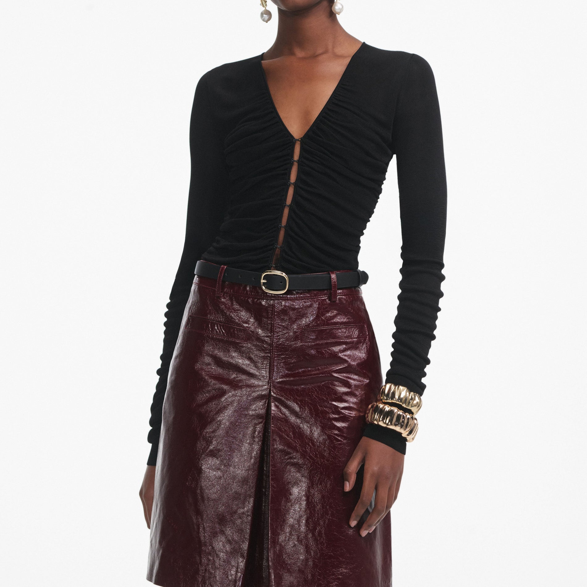 A close up of a woman wearing the Black Viscose Knit Top