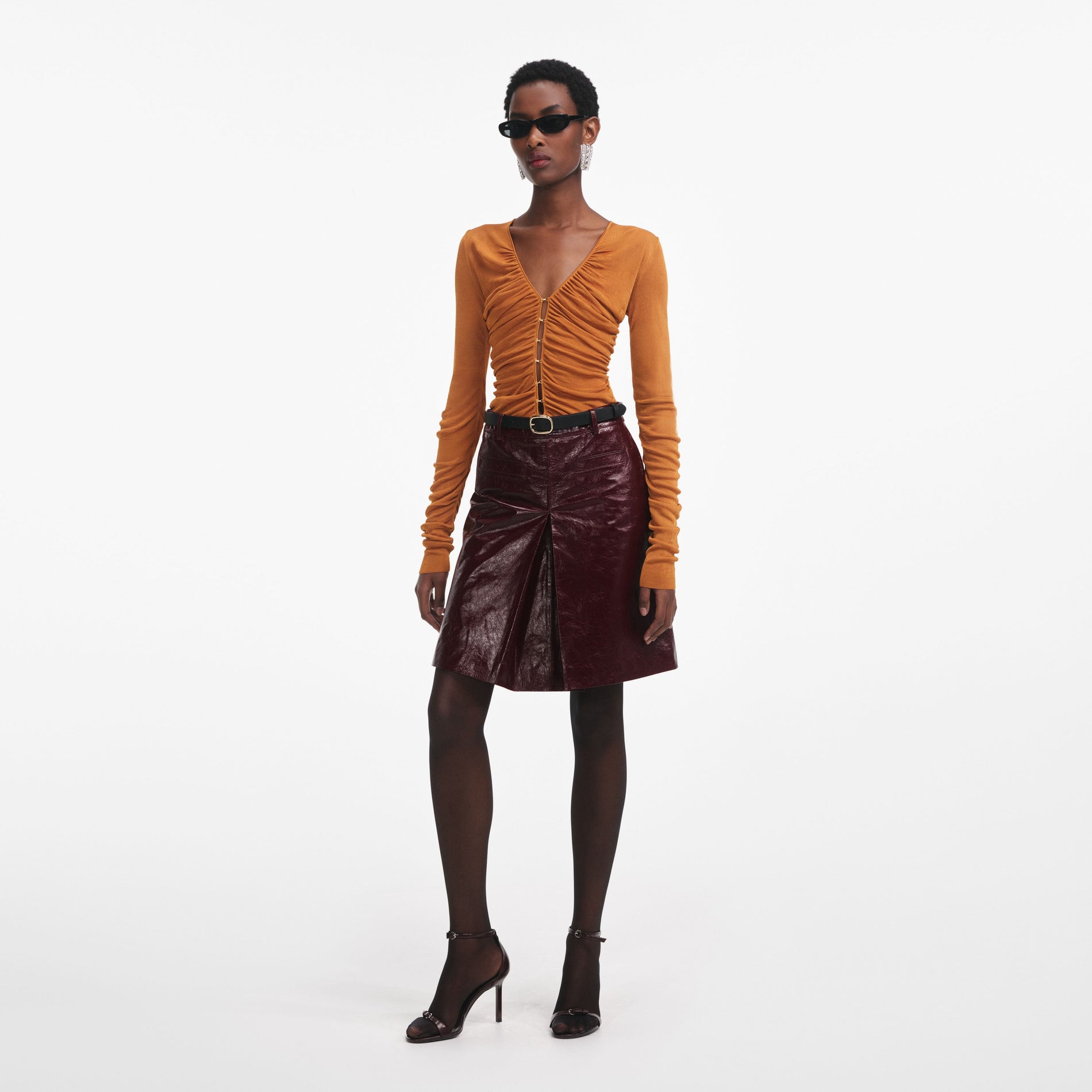 Front view of a woman wearing the Burnt Orange V Neck Viscose Knit Top