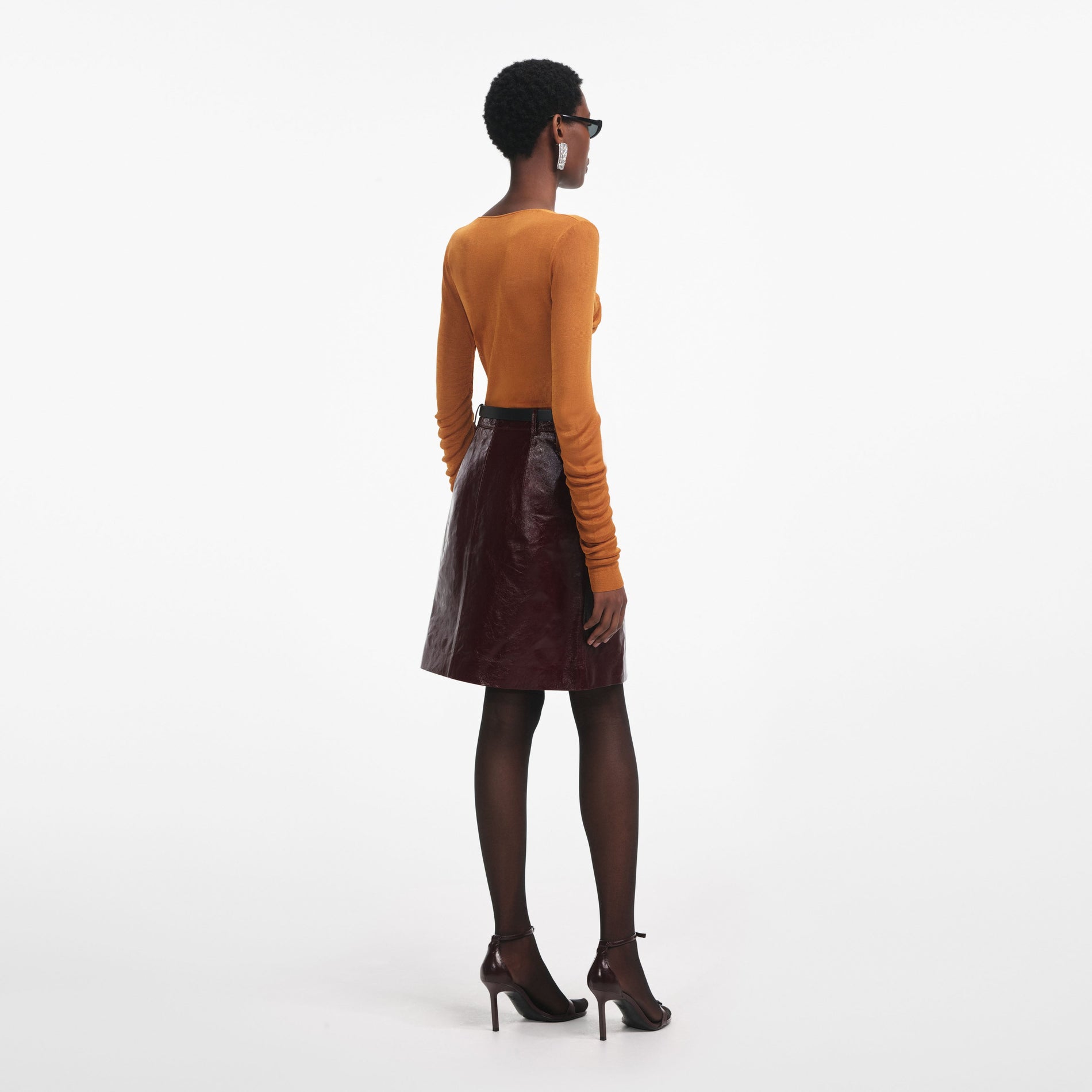 Back view of a woman wearing the Burnt Orange V Neck Viscose Knit Top