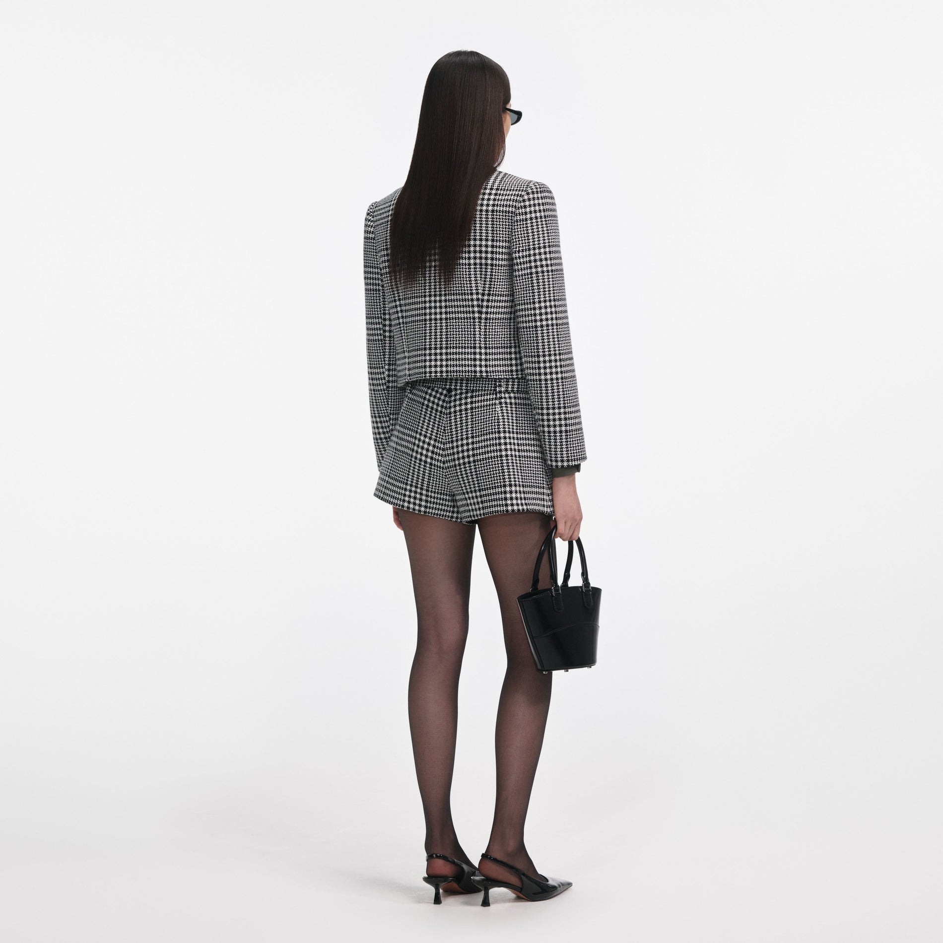 Back view of a woman wearing the Houndstooth Crystal Trim Jacket