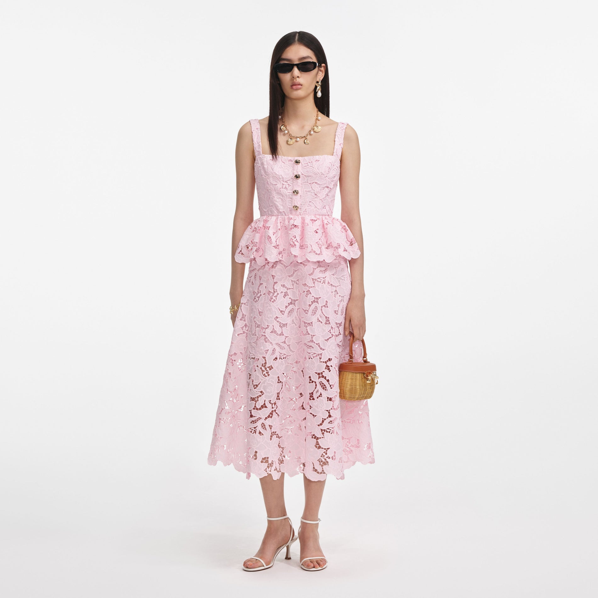 Front view of a woman wearing the Pink Lace Peplum Midi Dress