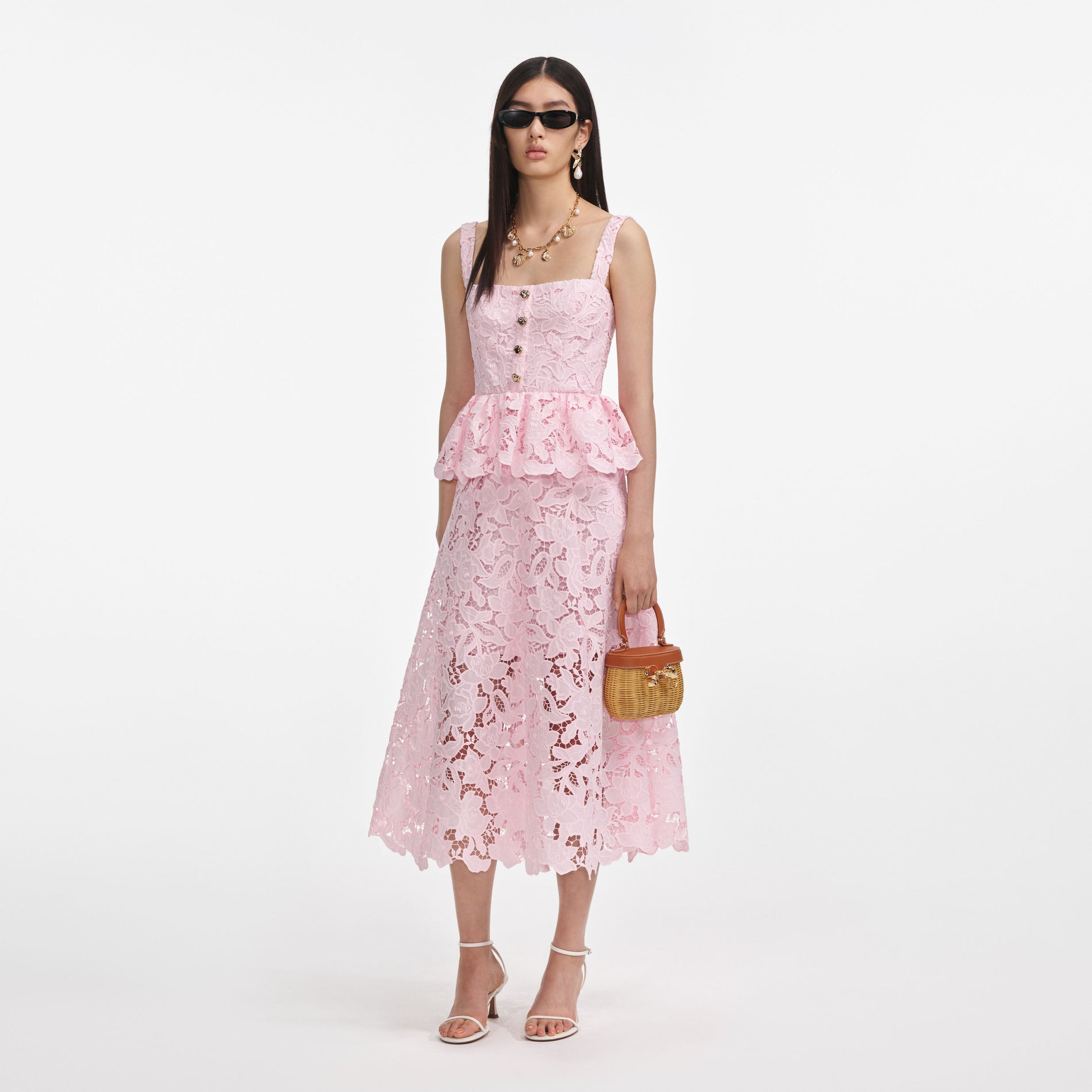 Side view of a woman wearing the Pink Lace Peplum Midi Dress