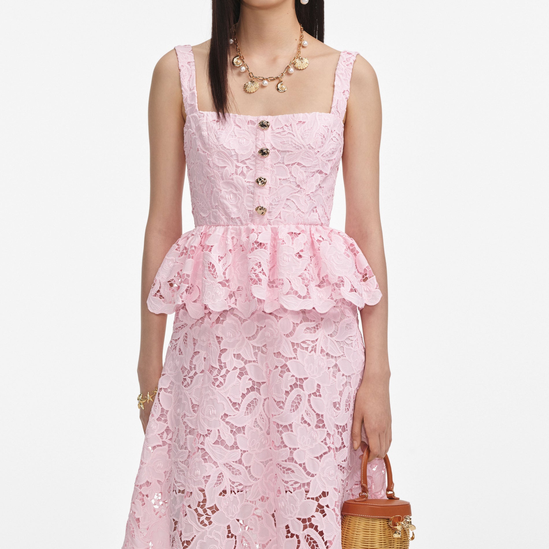 A close up of a woman wearing the Pink Lace Peplum Midi Dress