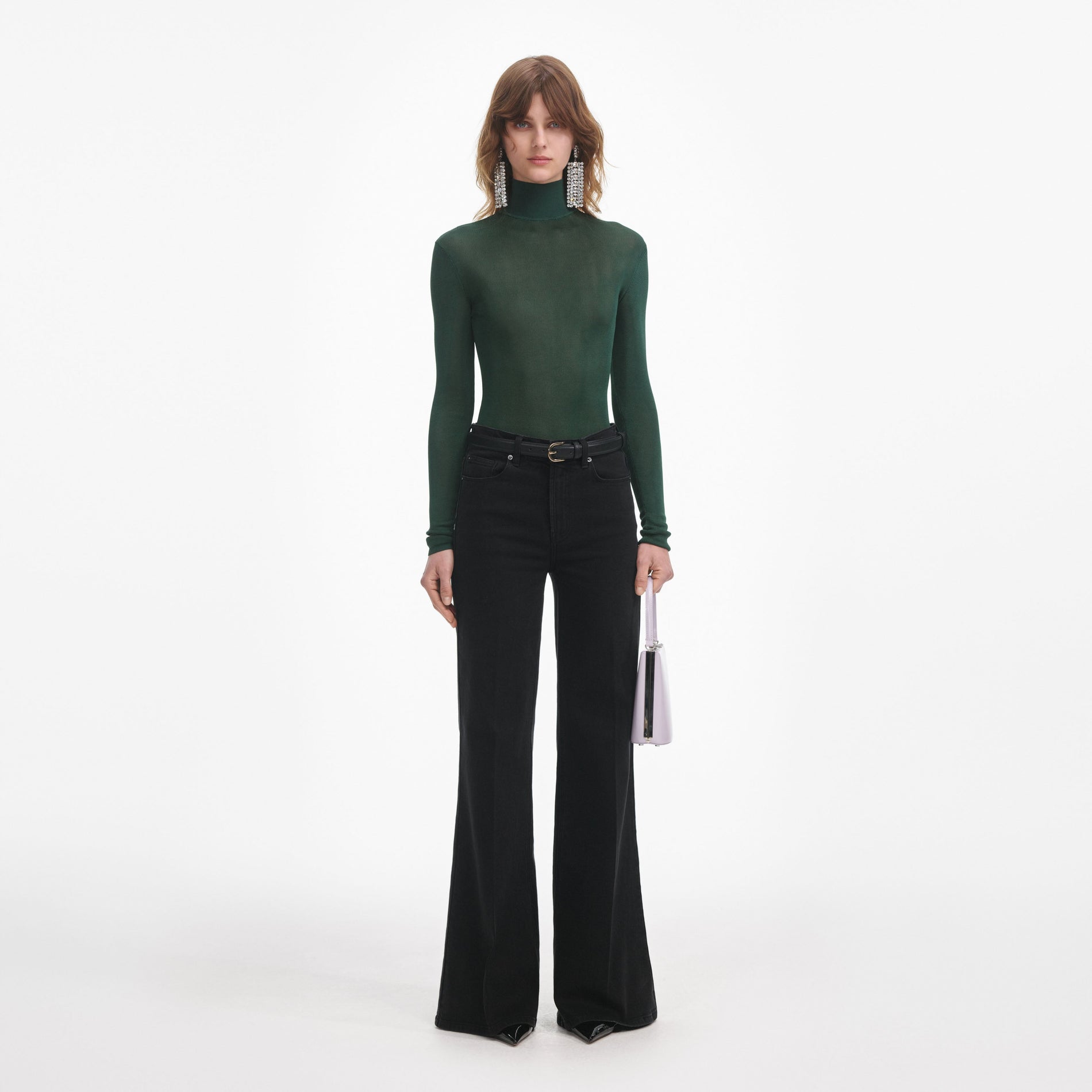 Front view of a woman wearing the Black Flared Jeans