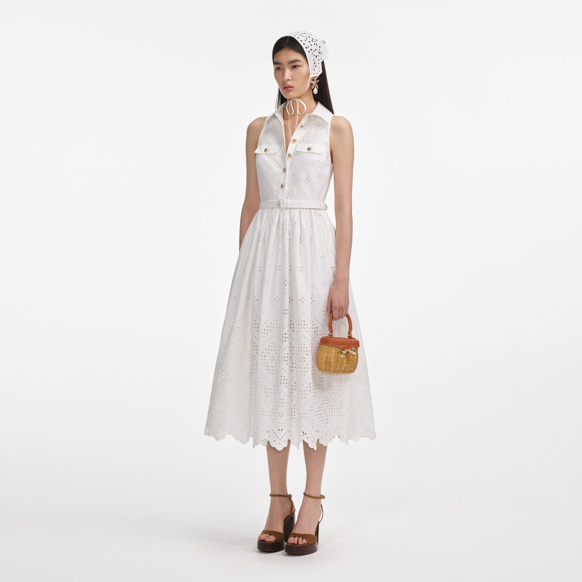 Side view of a woman wearing the White Cotton Broderie Collared Midi Dress